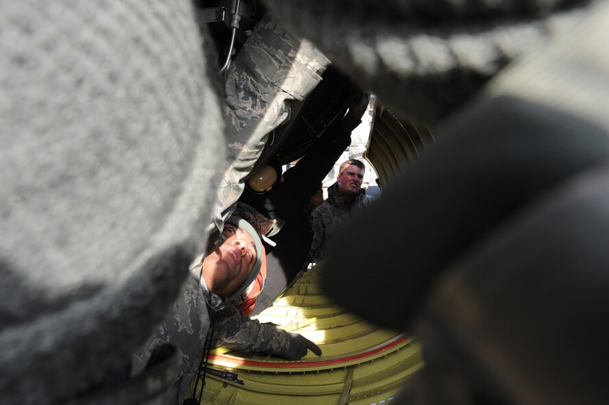 Airmen from the 2d Aircraft Maintenance Squadron secure connections on a replacement B-52 engine cowling during a conventional operational readiness exercise at Barksdale. The CORI measured the 2d Bomb Wing?s ability to deploy to a forward operating location in support of global contingency operations. (U.S. Air Force photo by Tech. Sgt. Mike Andriacco) (RELEASED)