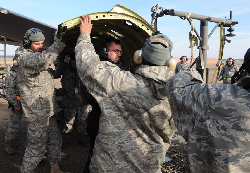 Airmen from the 2d Aircraft Maintenance Squadron place a faulty B-52 engine cowling onto a rack for removal during a conventional operational readiness inspection. The CORI ran from Dec. 7-14 and measured the 2d Bomb Wing?s ability to deploy to a forward operating location in support of global contingency operations. (U.S. Air Force photo by Tech. Sgt. Mike Andriacco) (RELEASED)