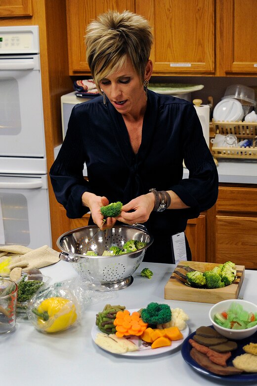 Health and Wellness Center registered dietitian Julie Anderson chops broccoli Dec. 3 for a cooking demonstration featuring healthy cooking for the holidays. Ms. Anderson hosts a cooking demo once a month at the HAWC, Building 560. The next demo will be at 6 p.m. Jan. 7 and features tips on how to prepare healthy food with your children. For details, call the HAWC at 556-4292. (Air Force photo by Larry Hulst)