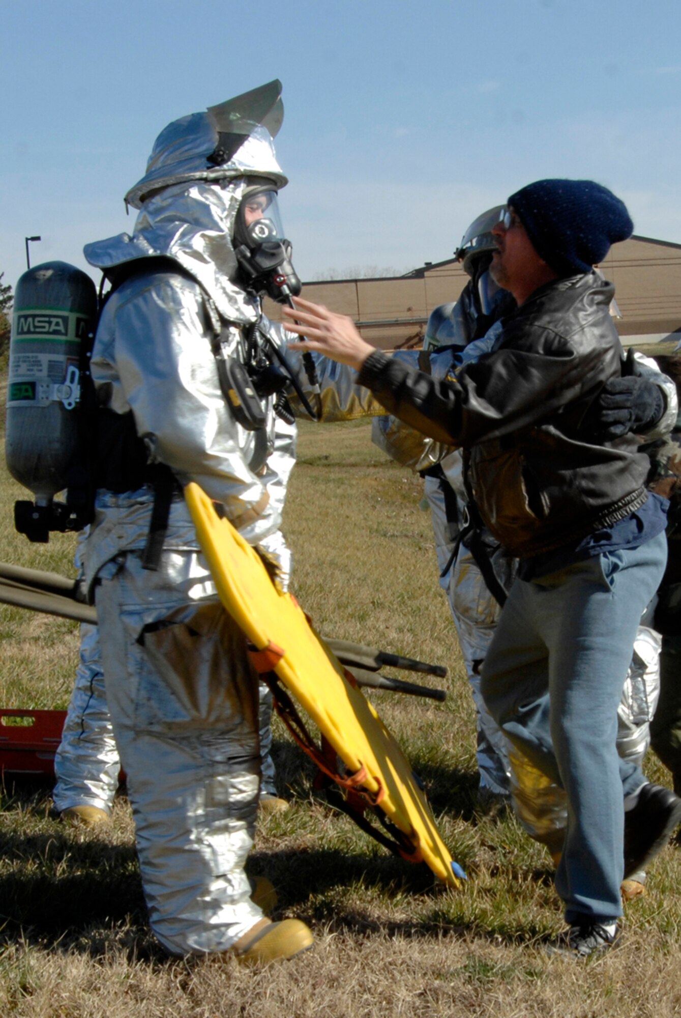 McConnell firefighters respond to the scene of a mock chemical attack, during a 22nd Medical Group exercise, Dec. 2, 2009, at McConnell Air Force Base, Kan. The firefighters secured the area and escorted Team McConnell members posing as attack victims from the site of the incident. (U.S. Air Force Photo/Airman 1st Class Justin A. Shelton)