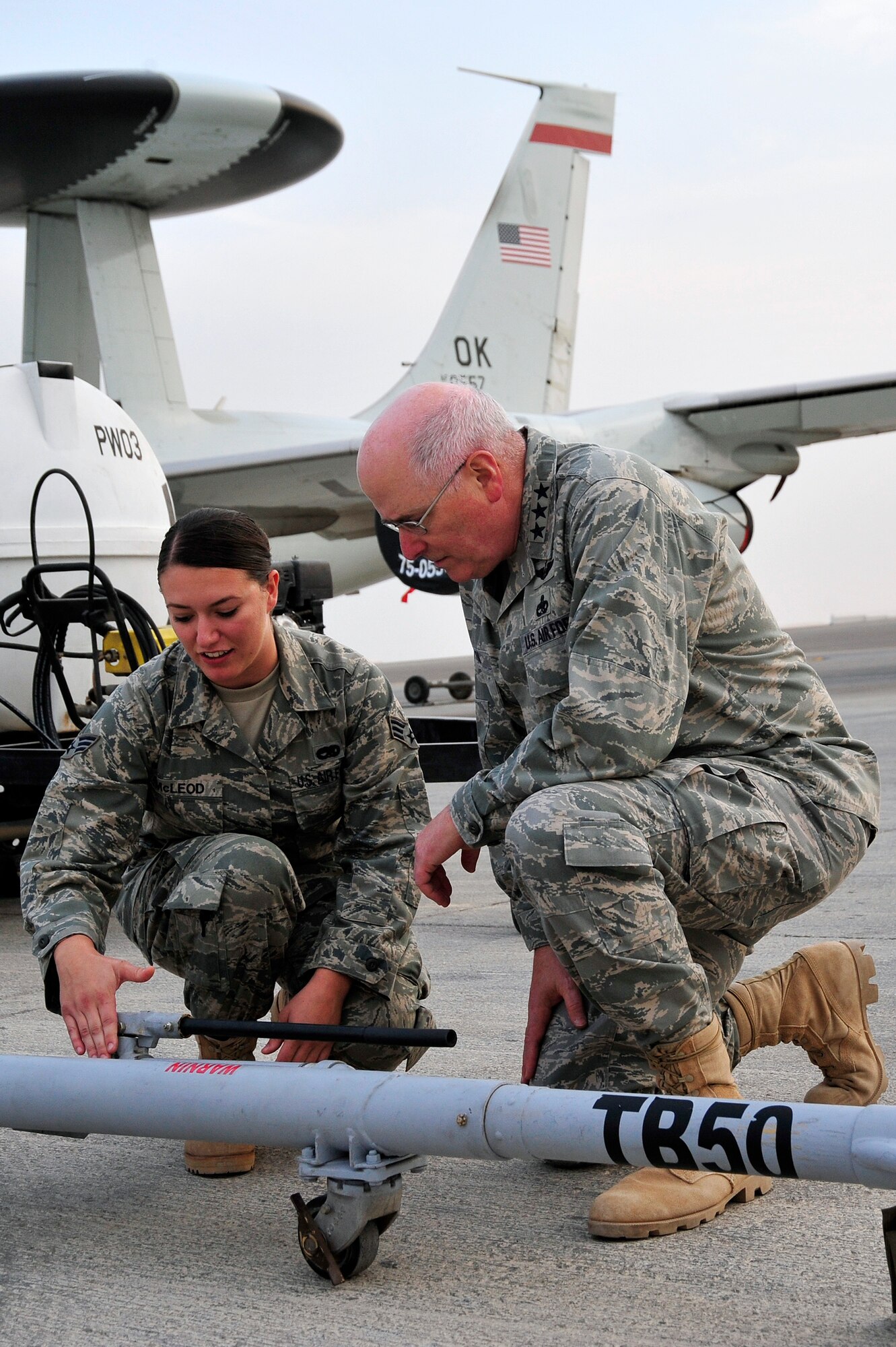 SOUTHWEST ASIA - Lt. Gen. Loren Reno, Deputy Chief of Staff for Logistics, Installations and Mission Support, listens to a brief from Senior Airman Shalane McLeod, 380th Expeditionary Maintenance Squadron aircraft ground equipment, on the operation of an aircraft tow-bar Dec. 10, 2009. Airman McLeod is deployed from Luke Air Force Base, Ariz., and grew up in Chicago, Ill. (U.S. Air Force photo/Tech. Sgt. Charles Larkin Sr)