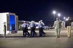 A U.S. Navy carry team transfers the remains of Navy Petty Officer 3rd Class David M. Mudge of Sutherlin, Ore., at Dover Air Force Base, Del., Dec. 9, 2009. Mudge, 22, died Nov. 28, in a non-hostile accident aboard USS Rentz while in Port Jebel Ali, United Arab Emirates. (U.S. Air Force photo/Jason Minto)