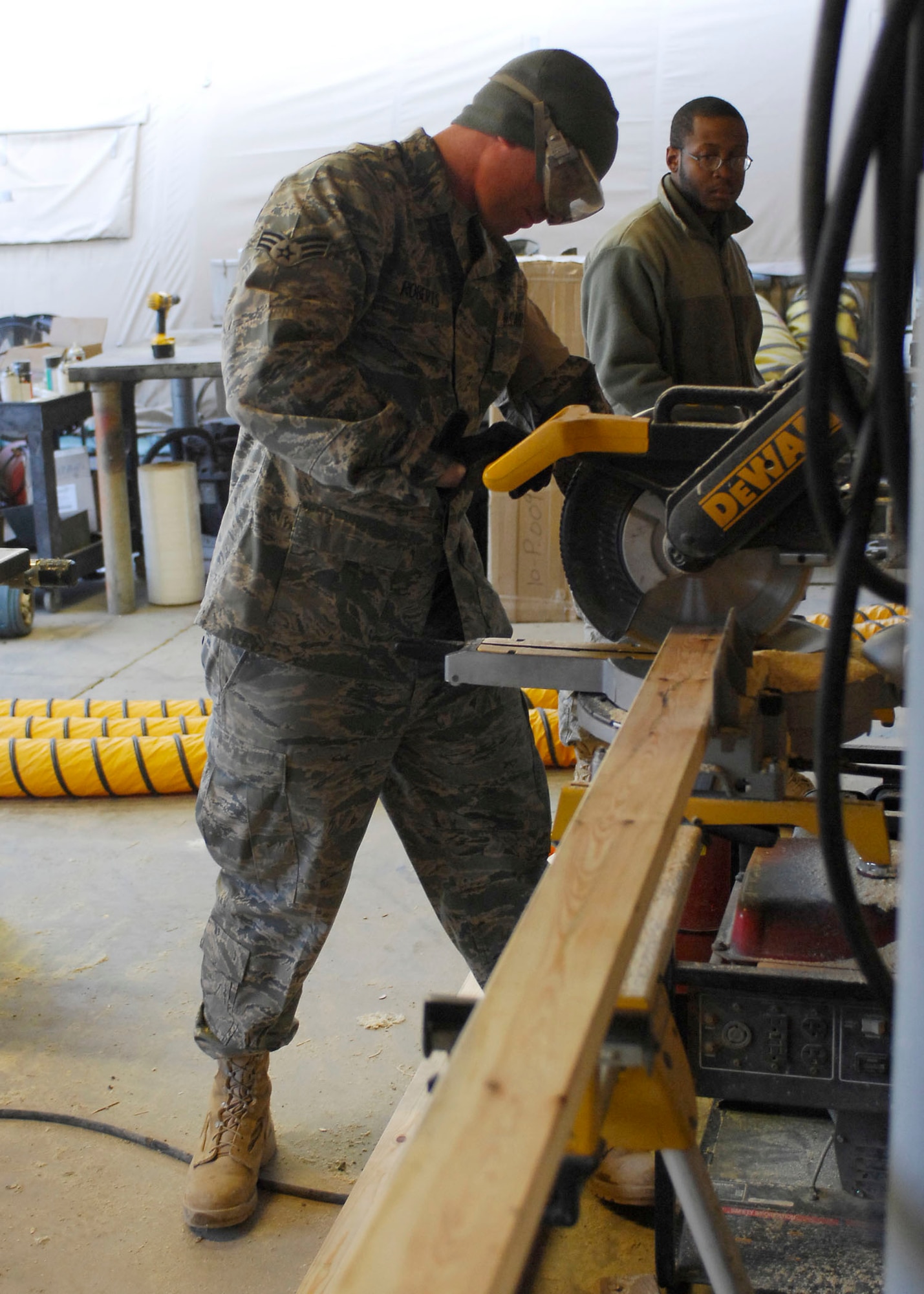 BAGRAM AIRFIELD, Afghanistan -- Senior Airman Matthew Roberts, a force protection Airman from the 455th Expeditionary Civil Engineering Squadron, cuts plywood in order to build shelves for the laundry services office, Dec. 11, 2009.  The shelves will be use to hold laundry waiting to be picked up by the growing population of Airmen.  Airman Roberts is deployed from Elmendorf Air Force Base, Alaska and hails from Hartford, Mich.  (U.S. Air Force photo/Senior Airman Felicia Juenke)