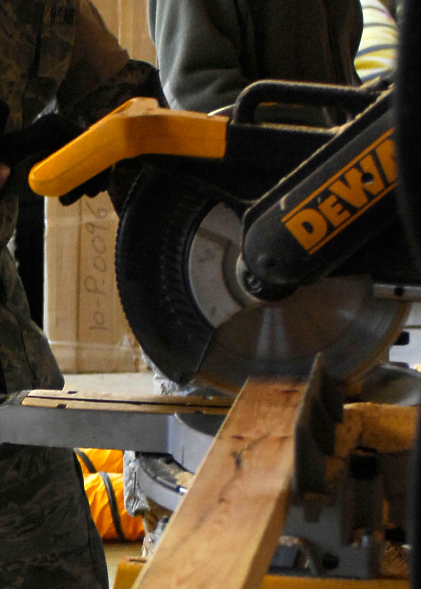 BAGRAM AIRFIELD, Afghanistan -- Airmen, from the 455th Expeditionary Civil Engineering Squadron, cut plywood in order to build shelves for the laundry services office, Dec. 11, 2009.  The shelves will be use to hold laundry waiting to be picked up by the growing population of Airmen.  (U.S. Air Force photo/Senior Airman Felicia Juenke)