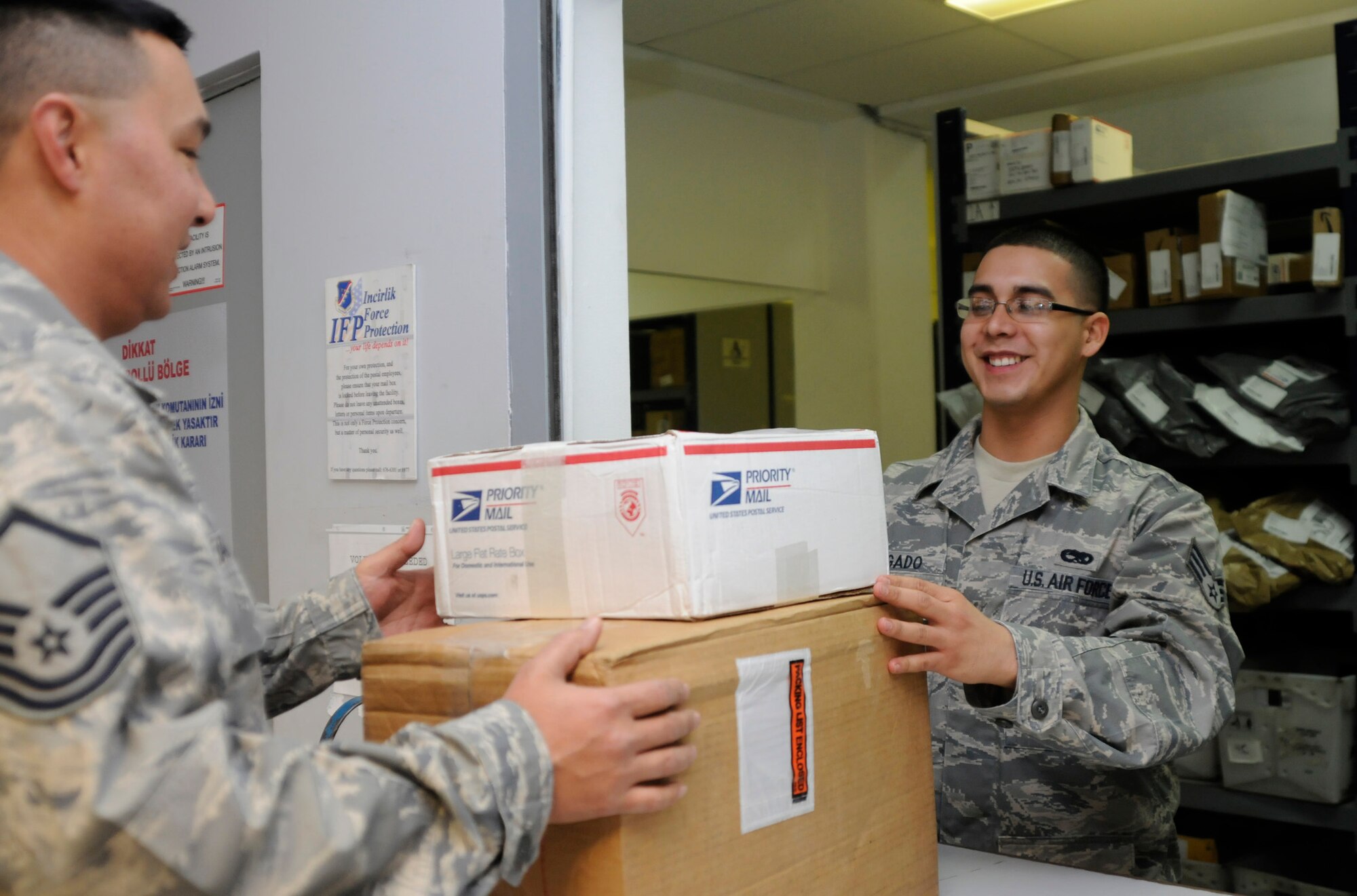Senior Airman Jose Delgado, 39th Official Document Center, gives a customer his packages Friday, Dec. 11, 2009 at the Incirlik ODC. The ODC has received more than 480,000 pounds of mail since Nov. 15 and have processed more than $82,000 worth of transactions from Incirlik personnel sending packages back to the U.S. (U.S. Air Force photo/Airman 1st Class Amber Ashcraft)