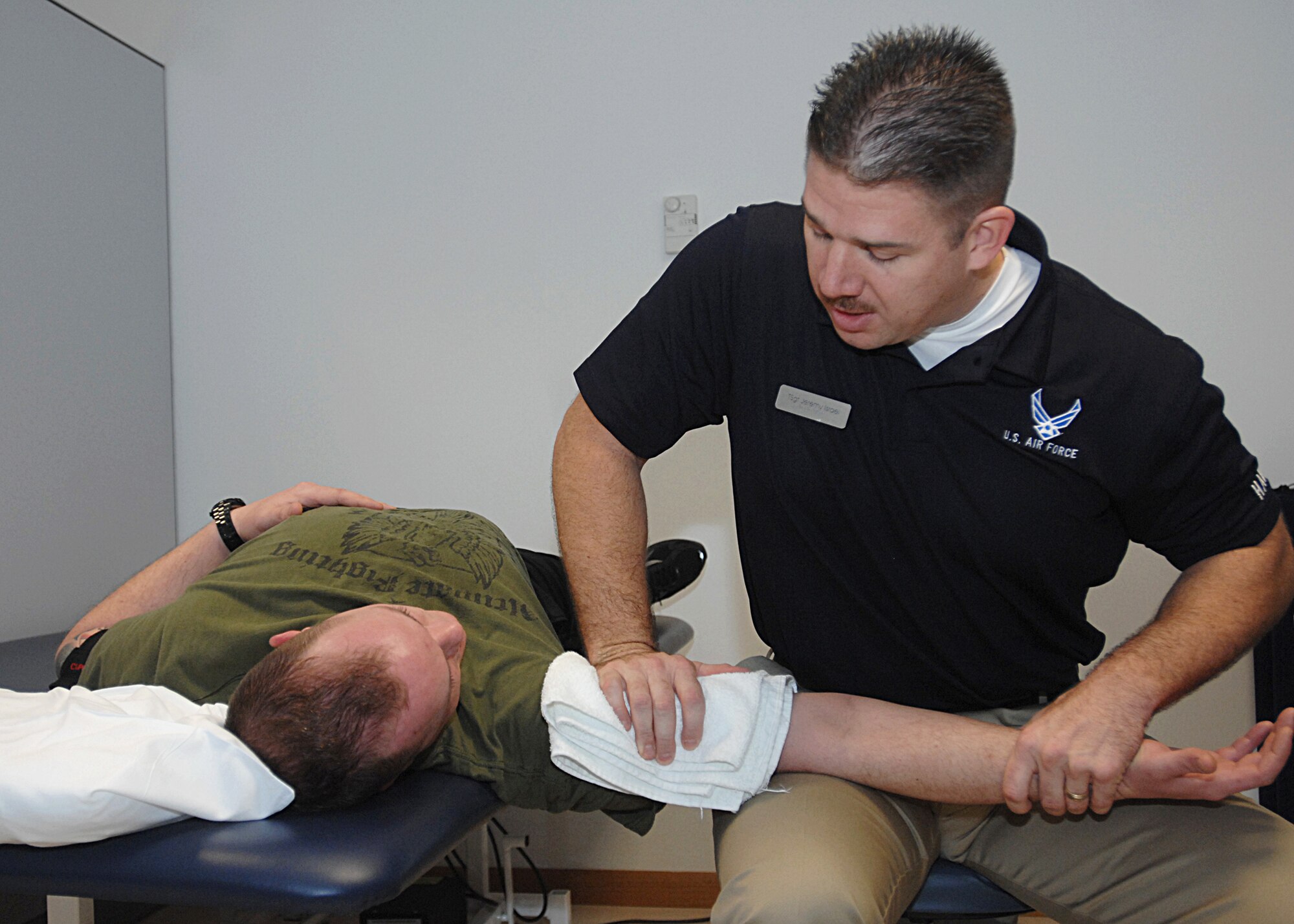 AVIANO AIR BASE, Italy --  Tech. Sgt. Jeremy Israel, 31st Aerospace Medical Squadron, performs range of motion exercises on Senior Airman Kyle Cupps, 31st Civil Engineer Squadron, during a physical therapy session at the Aviano Health and Wellness Center, Dec. 9, 2009.  The physical therapy clinic supports 350 visits per month between three personnel.  (U.S. Air Force photo/Senior Airman Tabitha M. Mans)