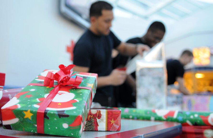 RAF MILDENHALL, England – Two neatly wrapped Christmas gifts are set aside while volunteers finish wrapping the remaining presents at the Base Exchange Dec. 10. Donations are being accepted with all proceeds going towards the American Red Cross. (U.S. Air Force photo/ Staff Sgt. Jerry Fleshman)