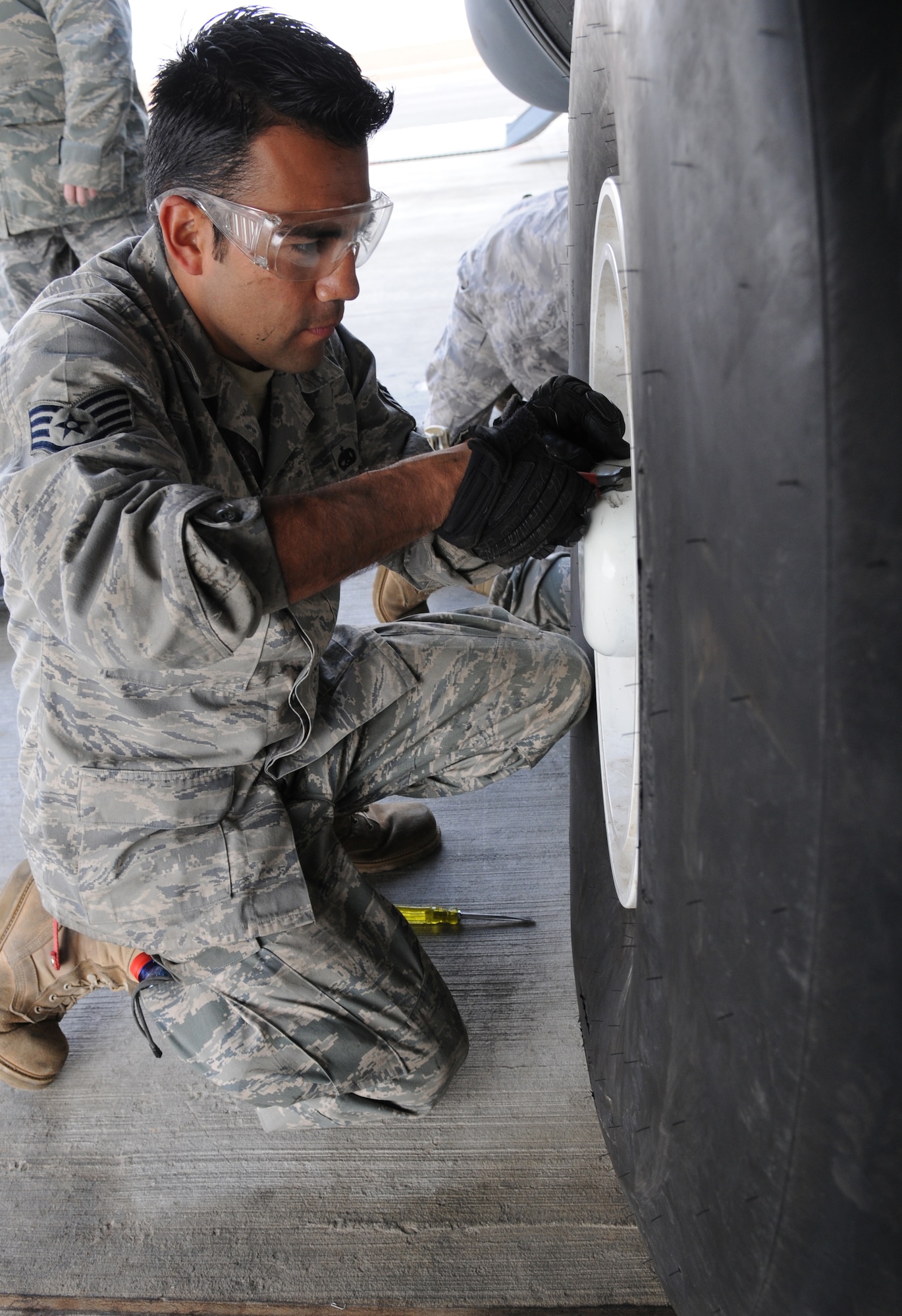 U.S. Air Force Staff Sgt. Richard Mora, 86th Maintenance Squadron aircraft hydraulics systems craftsman, gets ready to take off the tire of a C-130J Super Hercules, Nevatim Air Force, Israel, Dec. 9, 2009. Ramstein units participated in a 10-day training exercise to accomplish training requirements because of the strict air restrictions in Germany. (U.S. Air Force photo by Airman 1st Class Alexandria Mosness)
