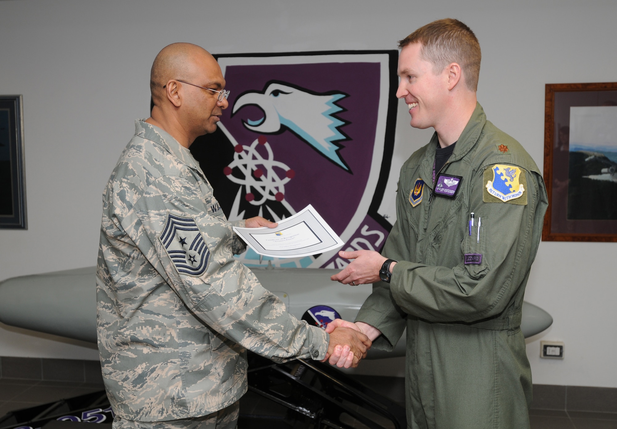 Chief Master Sgt. Laten Williams, 31st Fighter Wing command chief, congratulates  Maj. Jeff Montgomery, 510th Fighter Squadron flight commander and F-16 instructor pilot, on his selection as one of Aviano's Finest. (U.S. Air Force photo/ Staff Sgt. Patrick Dixon)