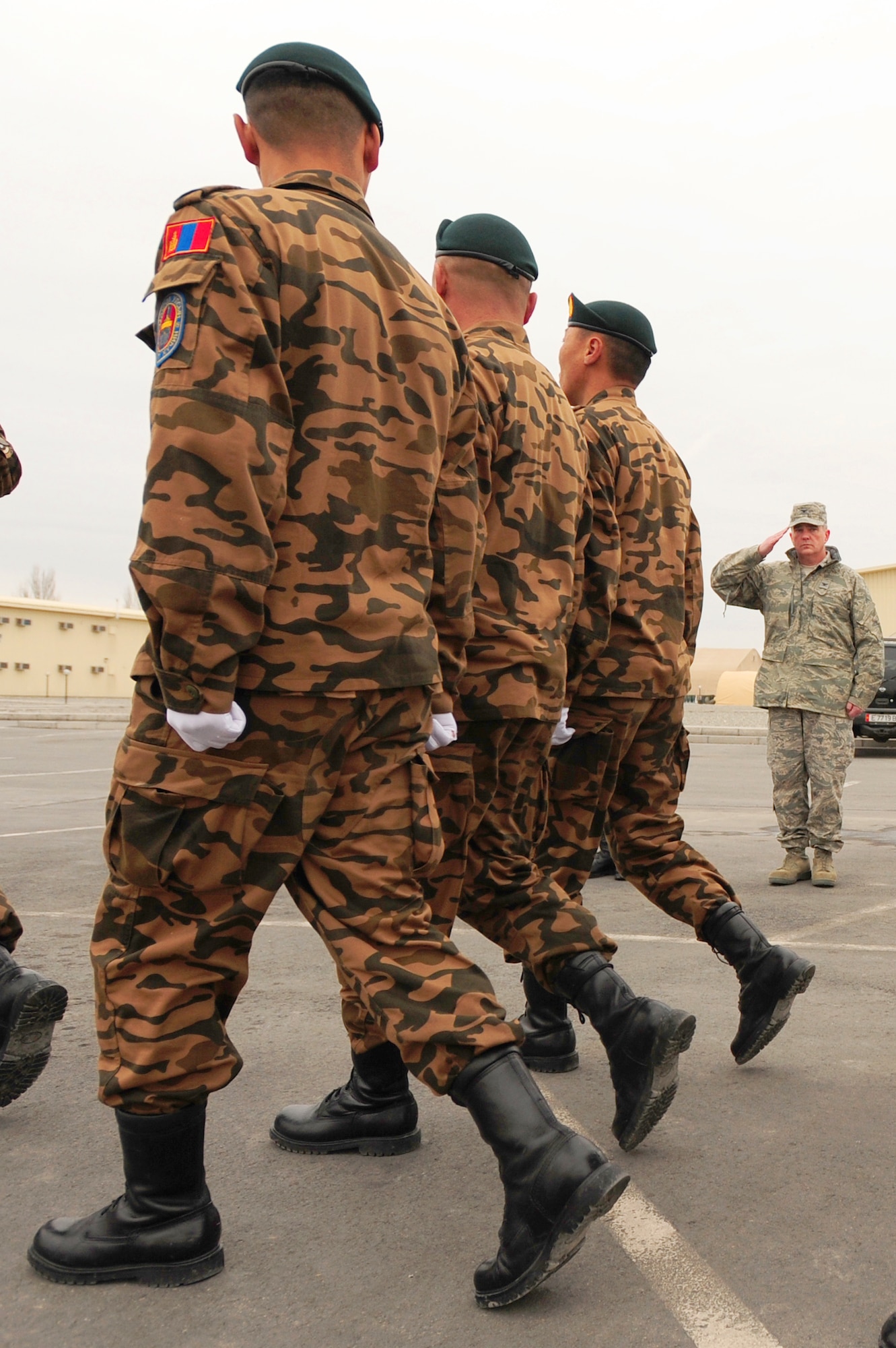 TRANSIT CENTER AT MANAS, Kyrgyzstan -- Col. Michael Mahon, 376th Air Expeditionary Wing vice commander, salutes Mongolian Army soldiers during a drill performance at the Transit Center. The soldiers stayed at Manas for several days before moving forward to Afghanistan is support of Operation Enduring Freedom. (U.S. Air Force photo/Senior Airman Steele C. G. Britton)