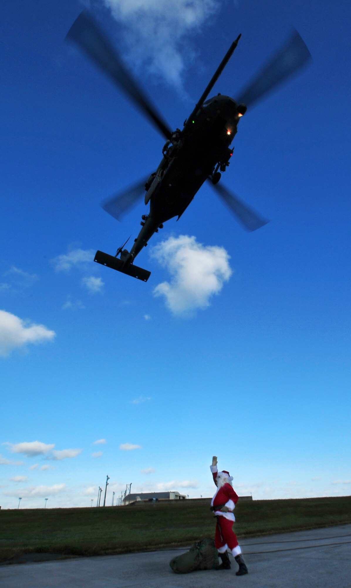 Santa Claus gives a wave to the pilots of a 33rd Rescue Squadron Pave Hawk before handing out presents to children attending a holiday homecoming party at the unit's maintenance hangar Dec. 10. The visit by Jolly old Saint Nick topped off a week when half of the "Jolly Green Giant" unit returned from a four-month deployment to Bagram Airfield, Afghanistan.  (Air Force/Tech. Sgt. Reynaldo Ramon)