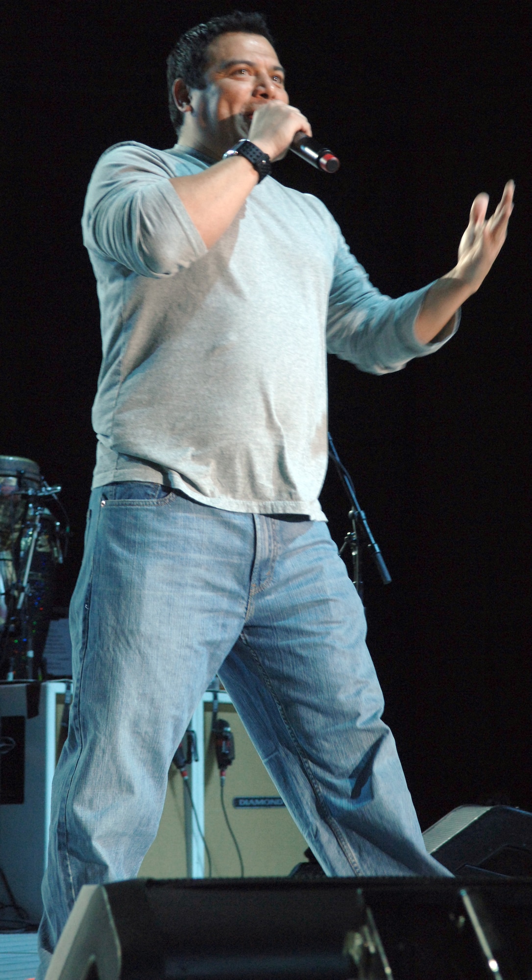 Comedian Carlos Mencia, known for his stand-up comedy skits and show "Mind of Mencia," brings laughter to Team Ramstein during his Tour for the Troops 2009 family performance in Hangar 1 Dec. 9, 2009, Ramstein Air Base, Germany. The comedian was joined by singer/songwriter Jessie James and headliner Kid Rock as they toured various bases in Europe and Southwest Asia. (U.S. Air Force photo by Senior Airman Amanda Dick)