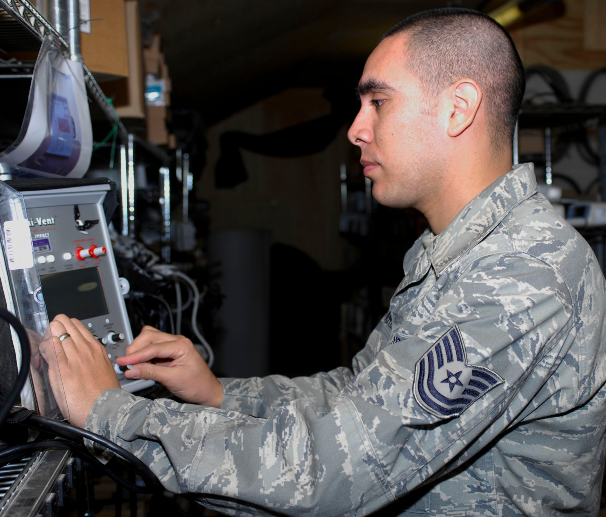 BAGRAM AIRFIELD, Afghanistan - Tech. Sgt. Jose Nevarez, the NCOIC of materiel management, performs an operational check on a ventilator used on aeromedical evacuation flights. His flight has assisted with more than 2,100 of the life-saving flights in his rotation. Sergeant Nevarez is deployed from Fairchild Air Force Base, Wash., and an El Paso, Texas native. (U.S. Air Force photo/Tech. Sgt. John Jung)
