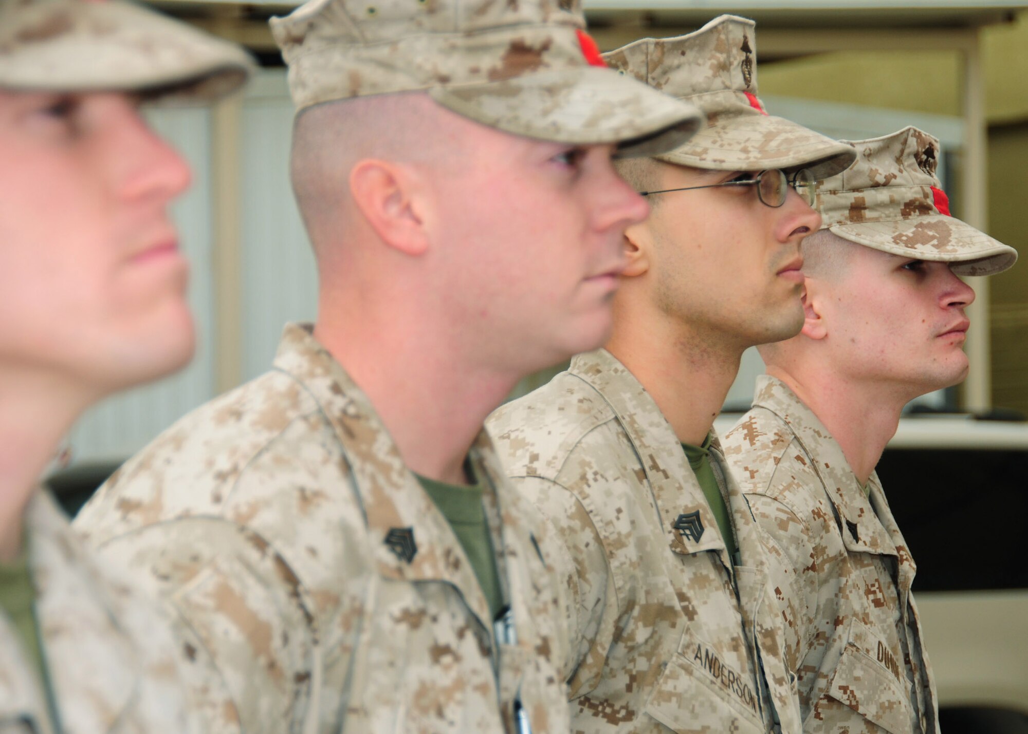 SOUTHWEST ASIA -- (From left to right) Sgt. Chance Larsen, Sgt. Brian Panton, Sgt. Joshua Anderson, and Cpl. Zane Dunn, the final rotation of Marines from the Arrival/Departure Airfield Control Group, also known as the Red Patcher’s, were recognized during a ceremony Dec. 10 to mark the completion of the unit’s mission at the airbase from which they operated in Southwest Asia.  (U.S. Air Force photo/Tech. Sgt. Tony Tolley)