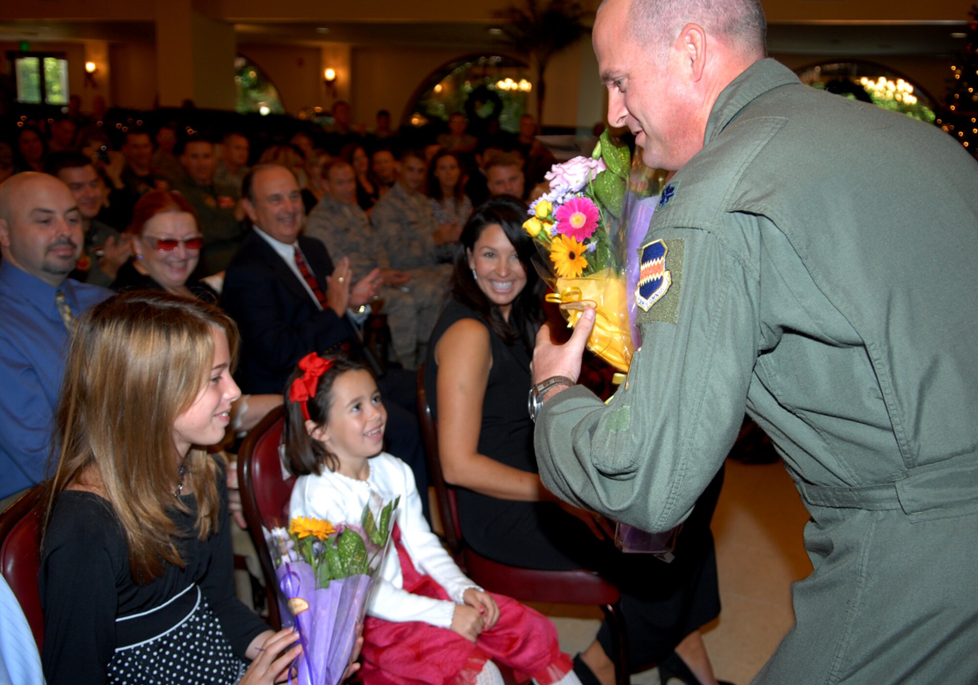 Lt. Col. R. Todd Daniel presents flowers to his daughters Alexandra and Erin
after assuming command of the 82nd Reconaissance Squadron at a ceremony at
the Kadena Officers' Club, Dec. 10, 2009. Lt. Col. Daniel replaces Lt. Col.
Bruce Mundie, who leaves Kadena for an assignment at Bolling Air Force Base,
Neb. The 82nd Reconaissance Squadron, flying the RC-135 Rivet Joint
aircraft, delivers timely, accurate, intelligence, surveillance and
reconnaissance data to warfighting commanders and national command
leadership. (U.S. Air Force photo/Junko Kinjo)
