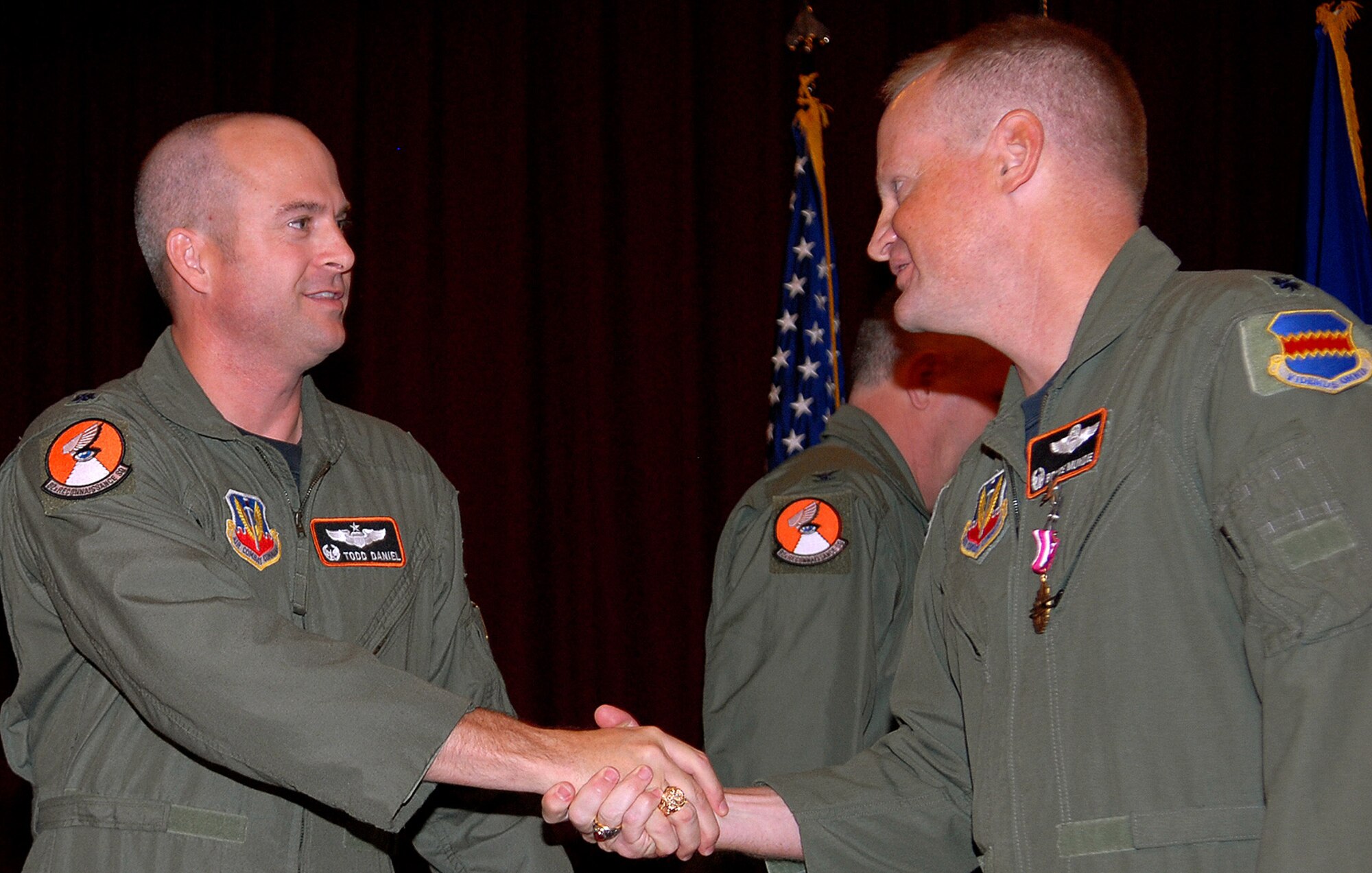 Lt. Col. Bruce Mundie, outgoing commander of the 82nd Reconaissance
Squadron, congratulates Lt. Col. R. Todd Daniel on his assumption of command
of the squadron Dec. 10, 2009 at a ceremony held at the Kadena Officers'
Club. The 82nd Reconaissance Squadron, flying the RC-135 Rivet Joint
aircraft, delivers timely, accurate, intelligence, surveillance and
reconnaissance data to warfighting commanders and national command
leadership. (U.S. Air Force photo/Junko Kinjo)

