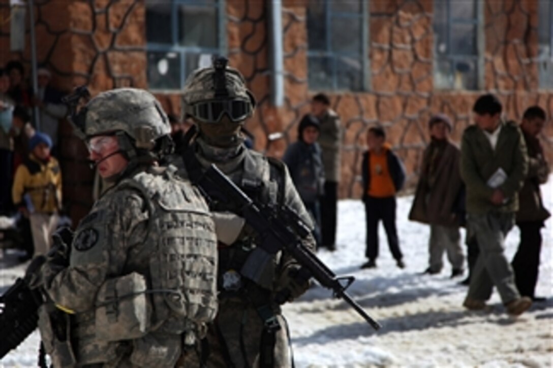 U.S. Army Sgt. John Newcomb and Spc. Wagner provide security in Salang, Afghanistan, on Nov. 25, 2009.  The soldiers are assigned to the 410th Military Police Company, 720th Military Police Battalion, 89th Military Police Brigade.  