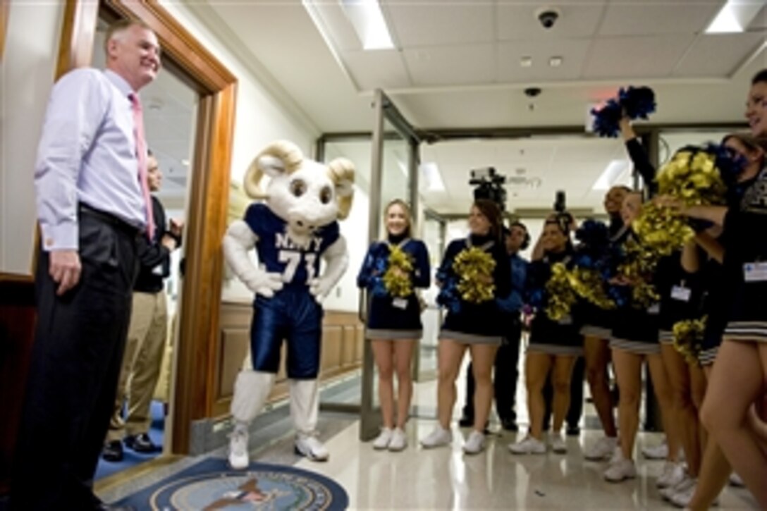 Deputy Defense Secretary William J. Lynn III greets the U.S. Naval Academy cheerleaders during a pep rally in the halls of the Pentagon Dec. 10, 2009, in anticipation of the annual Army-Navy football game, which will be played in Philadelphia on Saturday.
