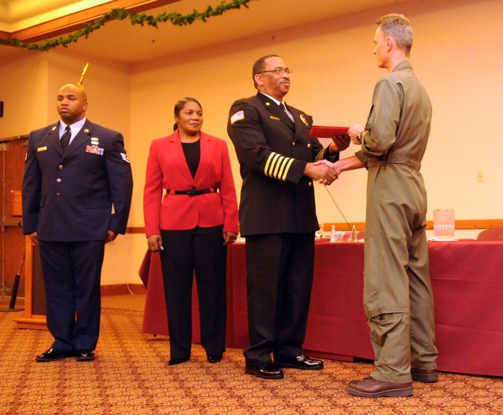 With his family by his side, station Fire Chief Patrick Bailey receives his certificate of retirement from station executive officer Lt. Col. Willis Price during his retirement ceremony at the Sonoran Pueblo at the Marine Corps Air Station in Yuma, Ariz., Dec. 11, 2009. A native of Glendora, Miss., Bailey retired after 34 years of service with the station fire department.  Under Bailey’s leadership, the department received the Department of Defense Fire Department of the Year in 2007, and received several personal awards, including Fire Officer of the Year, throughout his career. Bailey plans to use his retirement to spend more time with his family.