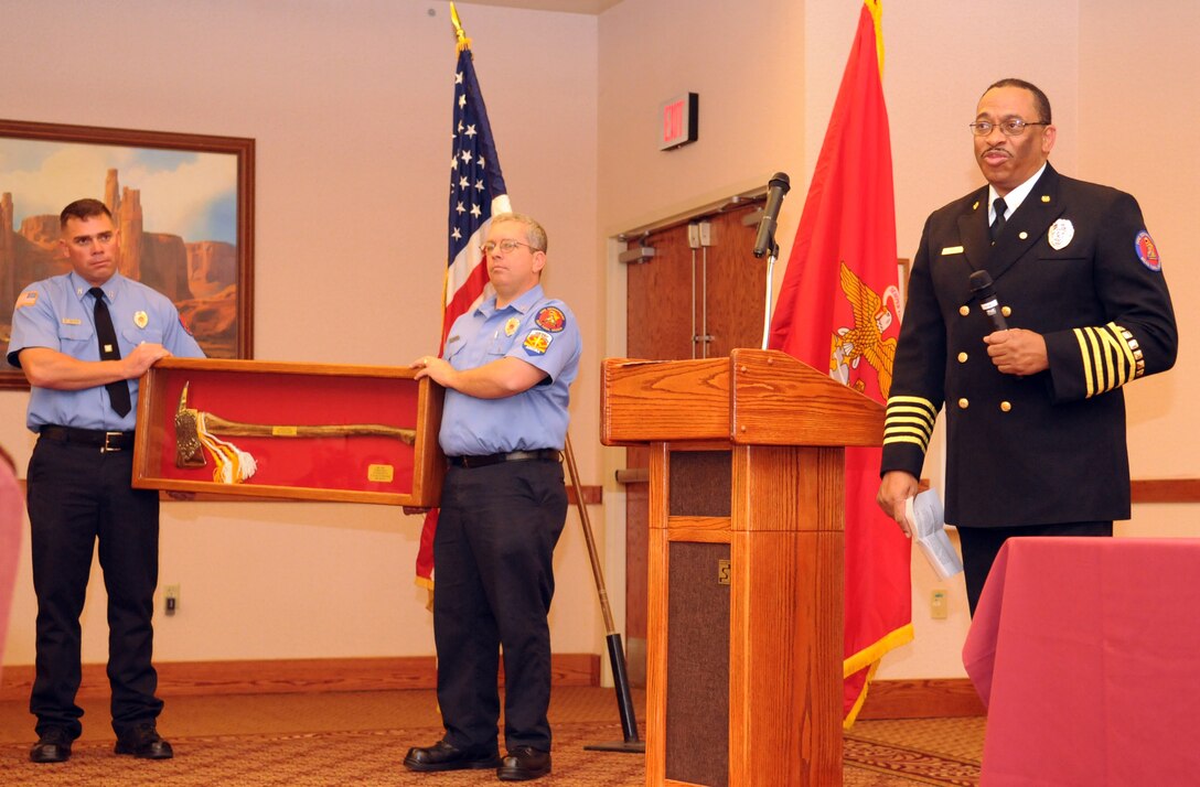 Station Fire Chief Patrick Bailey speaks to the crowd after being presented a gold-plated fire axe during his retirement ceremony at the Sonoran Pueblo at the Marine Corps Air Station in Yuma, Ariz., Dec. 11, 2009. A native of Glendora, Miss., Bailey retired after 34 years of service with the station fire department.  Under Bailey’s leadership, the department received the Department of Defense Fire Department of the Year in 2007, and received several personal awards, including Fire Officer of the Year, throughout his career. Bailey plans to use his retirement to spend more time with his family.