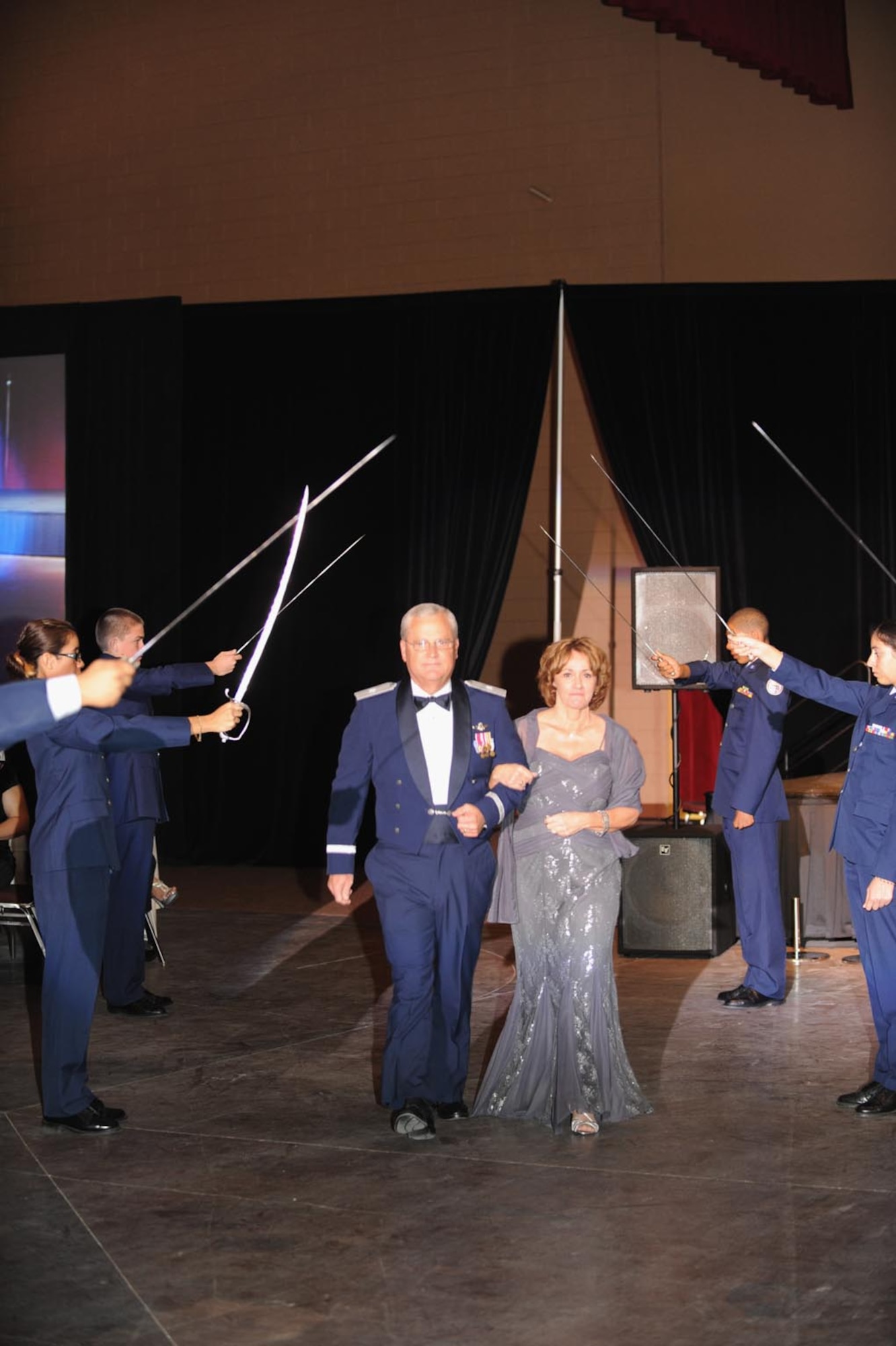 Brig. Gen. James Melin, 452 AMW commander, and his wife, Linda, walk through the sword arch.  (U.S. Air Force photo by Master Sgt. Roy Santana)