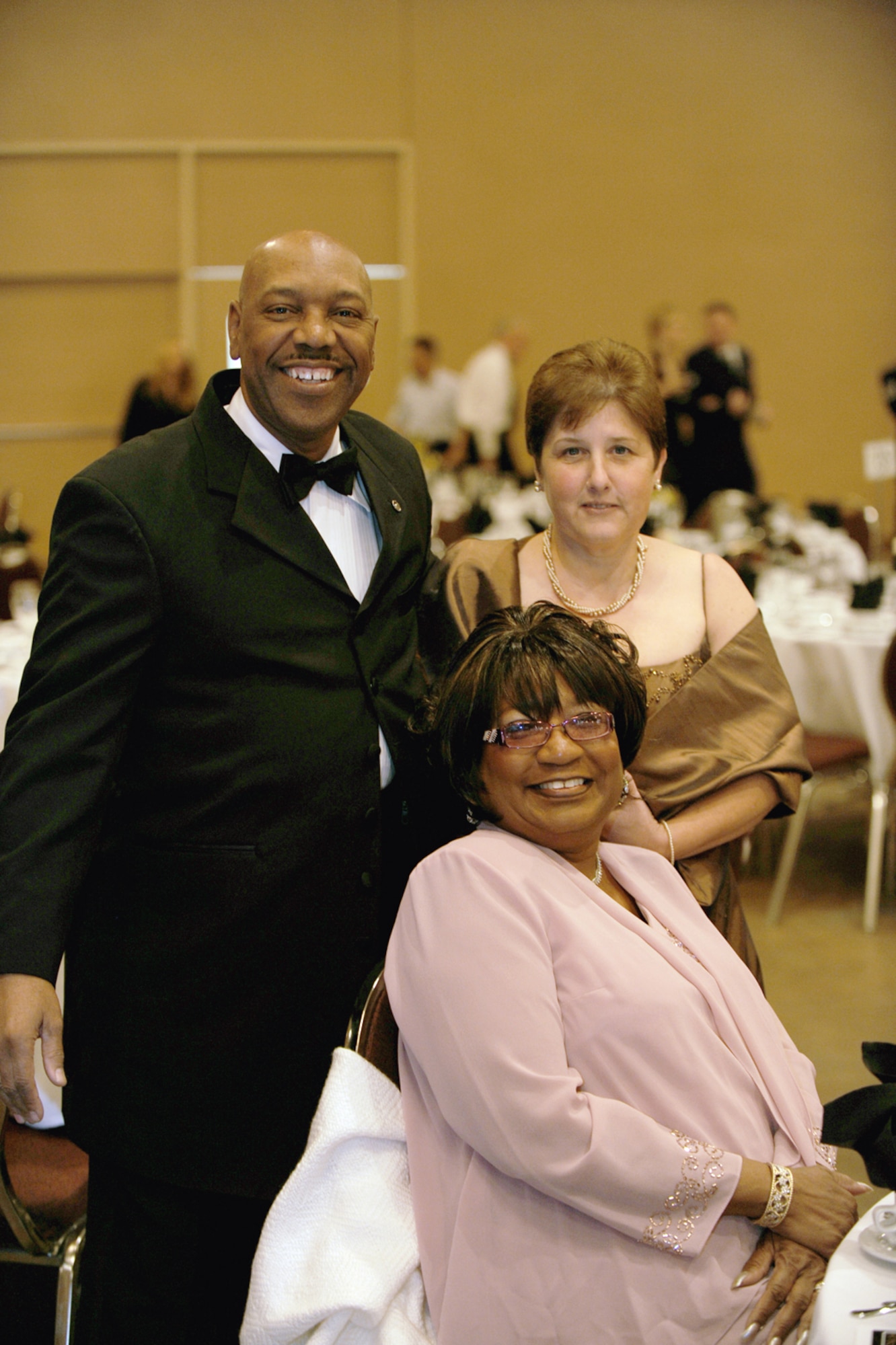 Kirby Love, from the 4th Combat Camera Squadron, takes a moment for a snapshot with his wife (in pink) and a friend. (U.S. Air Force photo by Master Sgt. Roy Santana)