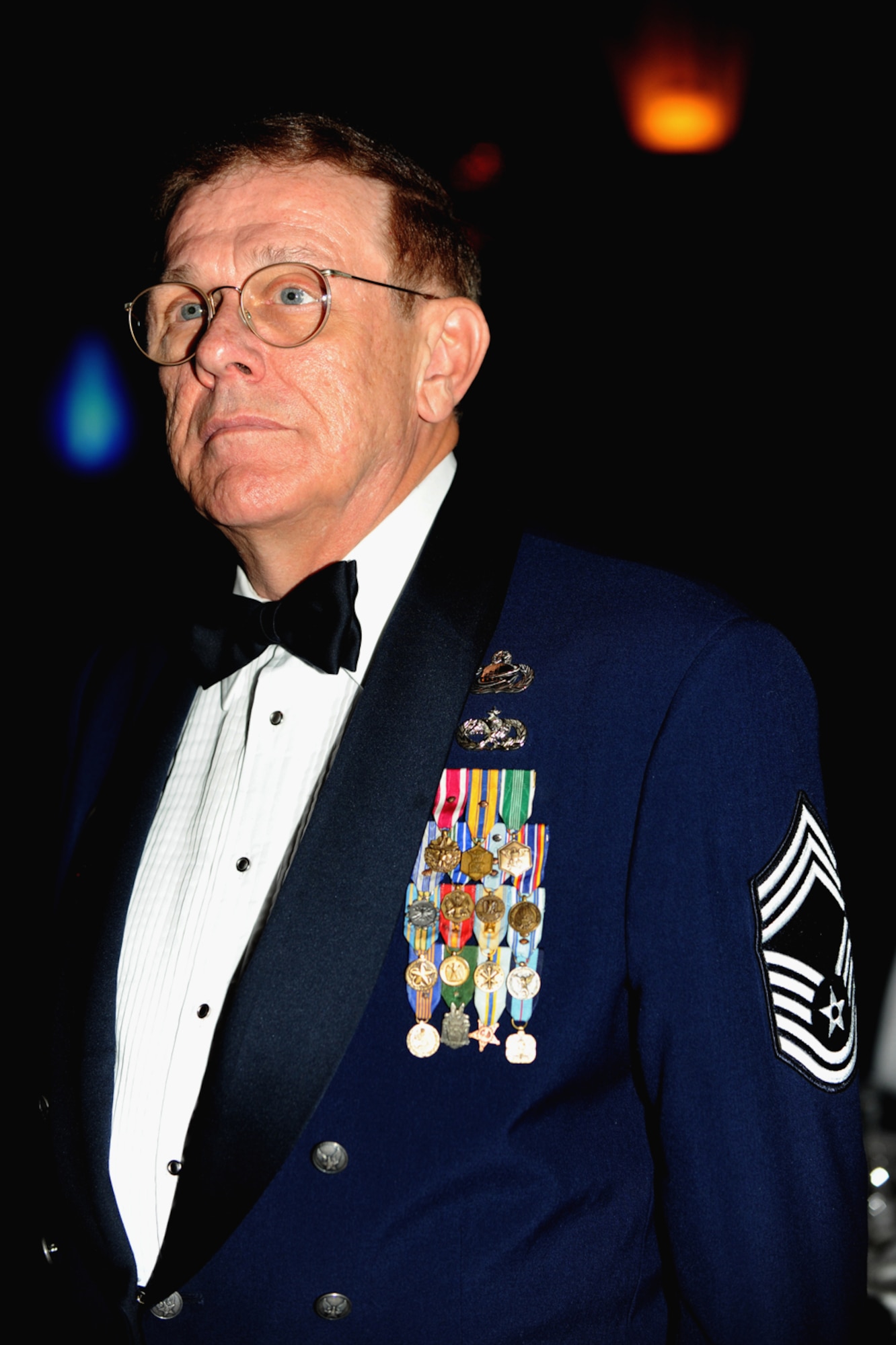 Guests stand during the singing of “The Star Spangled Banner,” the posting of the colors and the entry of distinguished parties. (U.S. Air Force photo by Master Sgt. Roy Santana)