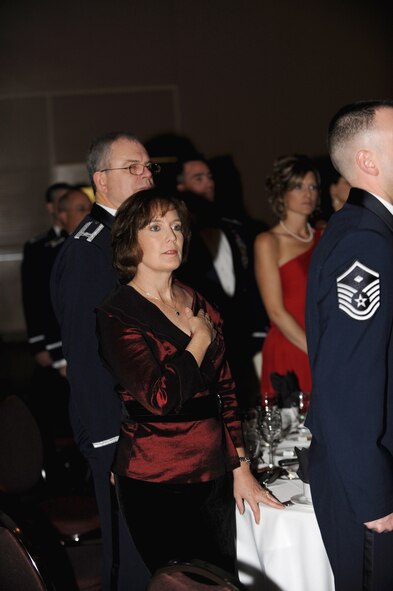 Guests stand during the singing of “The Star Spangled Banner,” the posting of the colors and the entry of distinguished parties. (U.S. Air Force photo by Master Sgt. Roy Santana)
