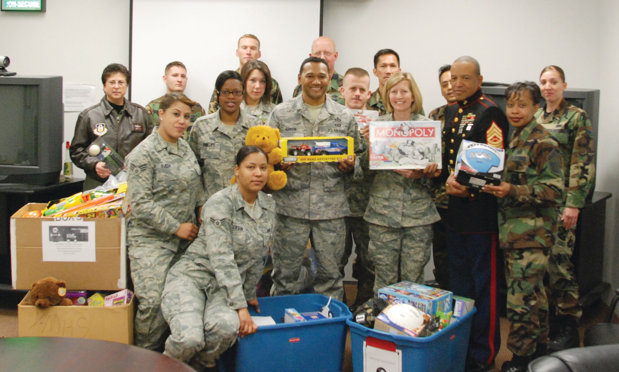 Marine Corps Master Sgt. (ret.) Wayne Harkley was at March Dec. 6 to collect Team March donations for the Toys for Tots program. Here, he poses with representatives from the Top Three and Ris¬ing Six and just a few of the estimated 250 donated toys. Senior Master Sgt. Barbara Morris, who organized the drive, began collecting toys nine months ago. As a single parent, she remembers how hard it was to find money for her kids’ Christmas presents and how appreciative she was when others would assist. This year, with the economic down¬turn, she knew a lot of families would be experiencing financial difficulties and she wanted to give back. Sergeant Morris and Team March members gave so many toys Sergeant Harkley couldn’t fit them all in his vehicle and Sergeant Mor¬ris had to arrange for a second pickup Dec. 9. ( U.S. Air Force photo by Staff Sgt. Kevin T. Chandler)
