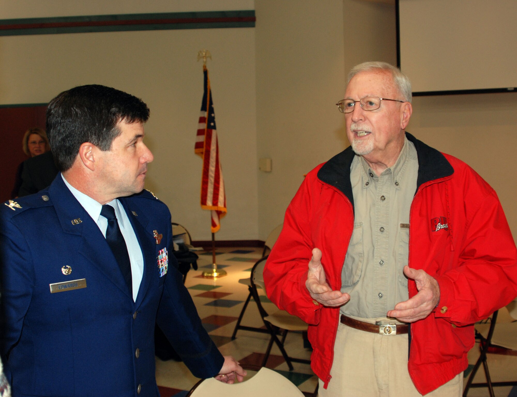 Col. William H. Edwards, Jr., commander of the 932nd Airlift Wing, Air Force Reserve Command, listens to a member of the Rotary after a luncheon held December 7.  He shared his thoughts on Pearl Harbor Day and the wing's mission as part of Air Force Reserve Command.  The mission of the 932nd Airlift Wing is to provide first-class, worldwide, safe, and reliable airlift for distinguished visitors and their staffs on the wing's C-9C and C-40C aircraft for VIP special assignment missions. The wing reports to Fourth Air Force at March Air Reserve Base, Calif.

