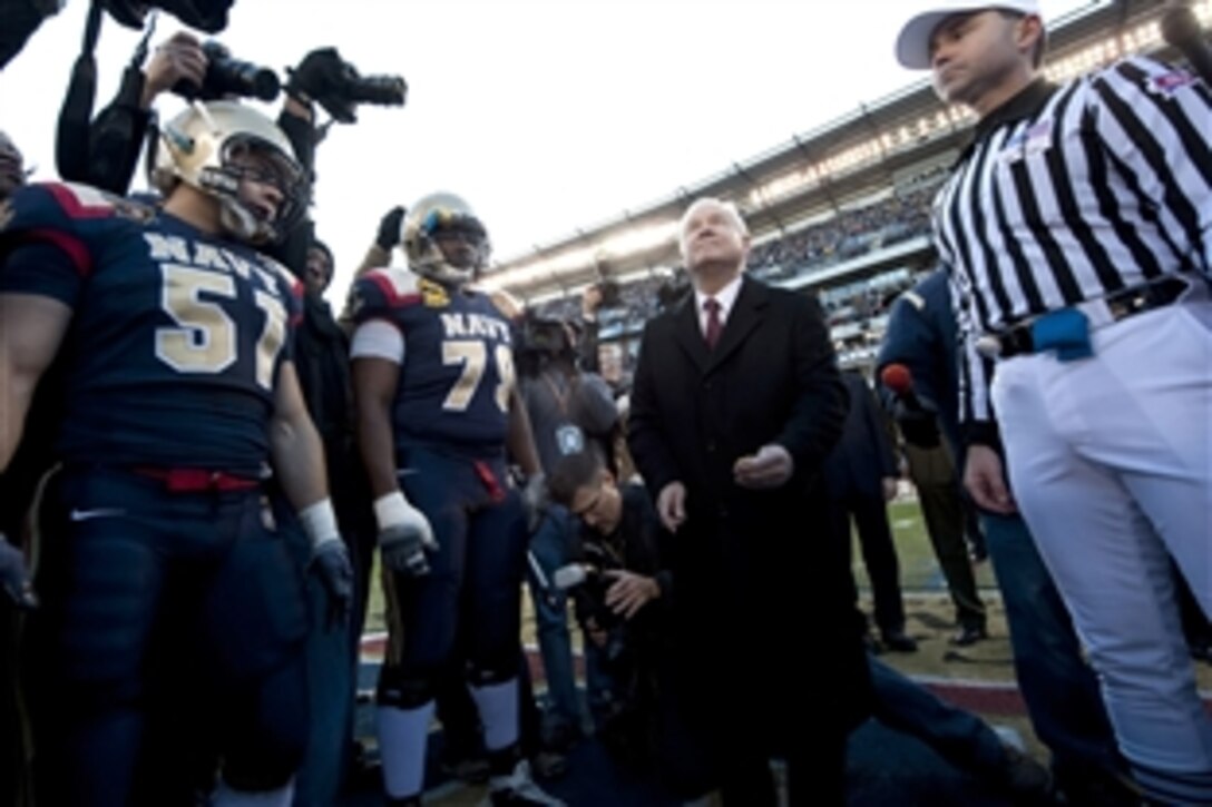 Defense Secretary Robert M. Gates flips the coin at the 110th Army-Navy football game at Lincoln Financial Field in Philadelphia, Dec. 12, 2009. 