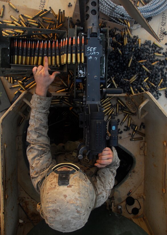 Lance Cpl. Richard Mueller, a rifleman serving with the Magnificent Bastards, the ground-combat element of the 11th Marine Expeditionary Unit, mans a .50 caliber machine gun at a practice range here Dec. 12.