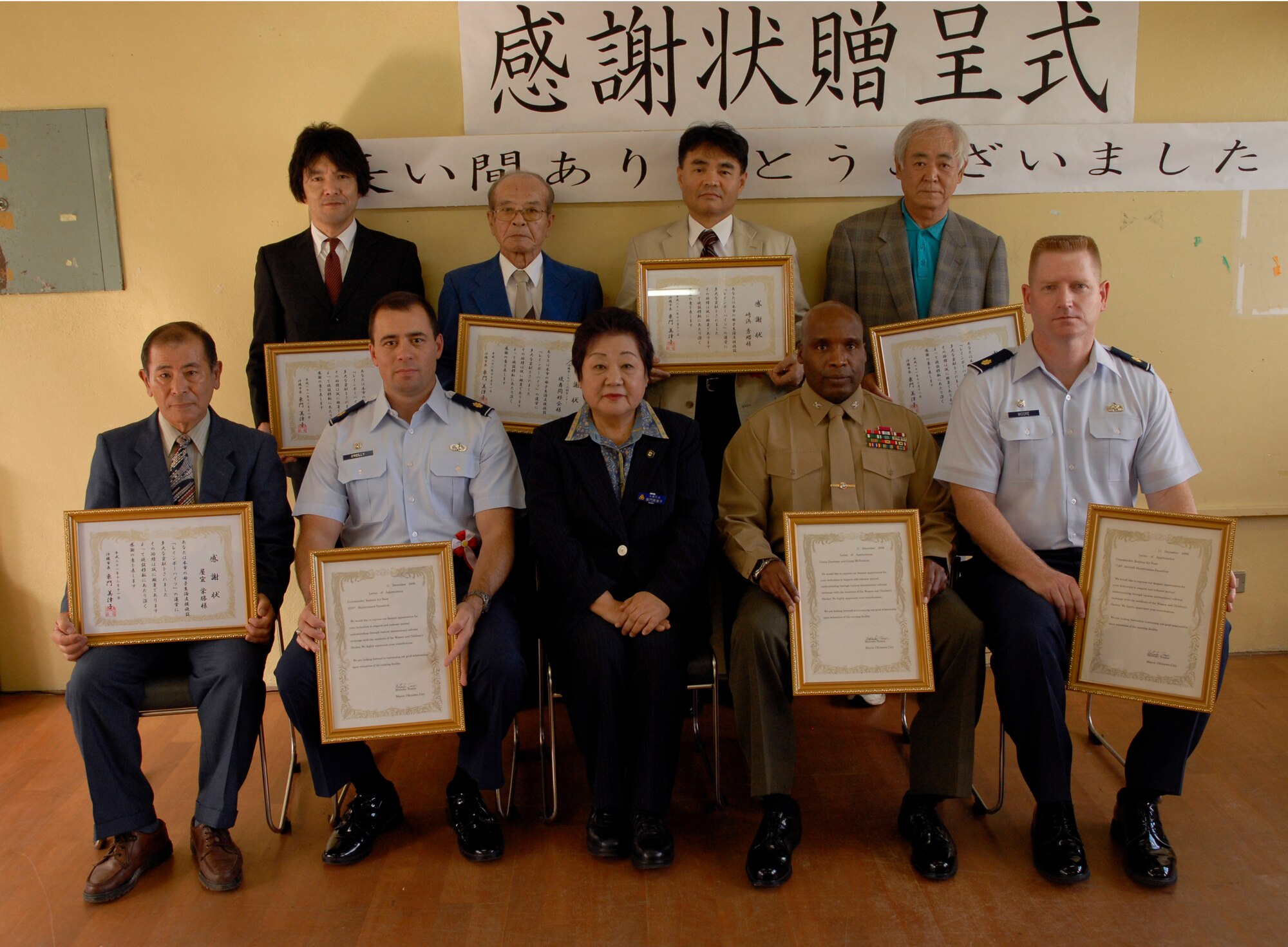 Kadena volunteers pose with Okinawa City Mayor Mitsuko Tomon (center) Dec. 11 at the Rainbow Heights Single Mothers Shelter in Okinawa City. The volunteers were recognized for their ongoing efforts with the shelter. (U.S. Air Force photo/Airman 1st Class Chad Warren)