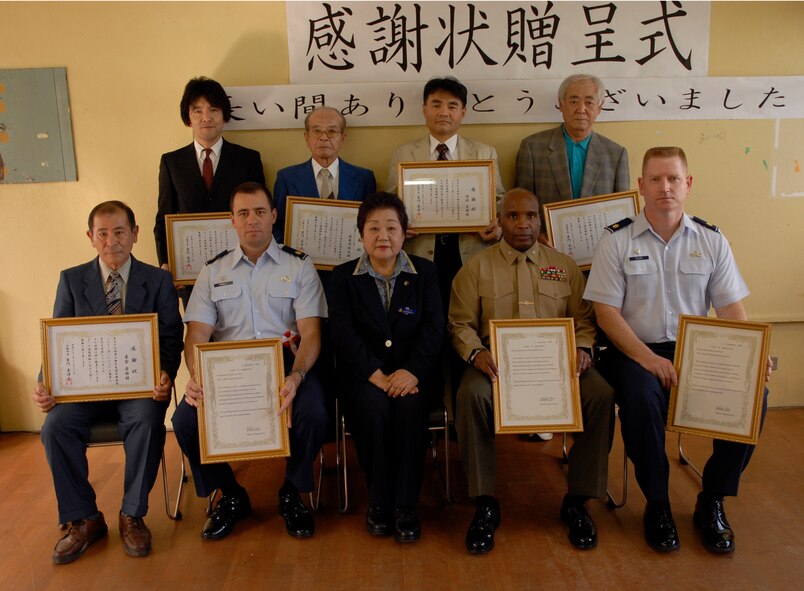 Kadena volunteers pose with Okinawa City Mayor Mitsuko Tomon (center) Dec. 11 at the Rainbow Heights Single Mothers Shelter in Okinawa City. The volunteers were recognized for their ongoing efforts with the shelter. (U.S. Air Force photo/Airman 1st Class Chad Warren)