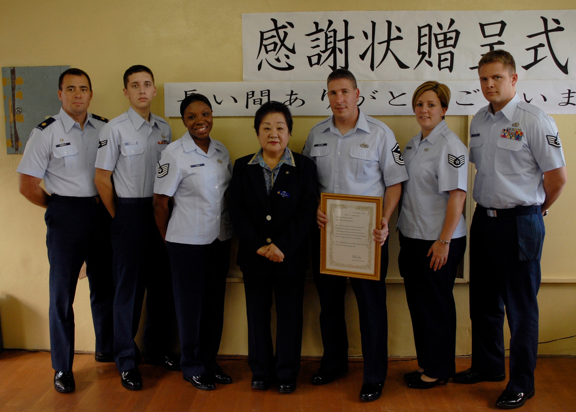 Airmen from the 353rd Maintenance Squadron pose with Okinawa City Mayor Mitsuko Tomon Dec. 11 at Rainbow Heights Single Mothers Shelter. The volunteers were recognized for their ongoing efforts with the shelter. (U.S. Air Force photo/Airman 1st Class Chad Warren)