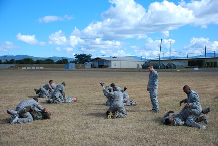 SOTO CANO AIR BASE, Honduras — Students practice submissions drills Dec. 8 near the base soccer fields. Thirty five members of Joint Task Force-Bravo recently participated in an Army level-one combative certification course from Dec. 7 to 11. Students learned everything from basic fighting positions to submissions and clenches to sweeps and take downs in the five-day course. On the final day the students turned the table and taught the instructors what they had learned in the previous days (U.S. Air Force photo/Staff Sgt. Chad Thompson).