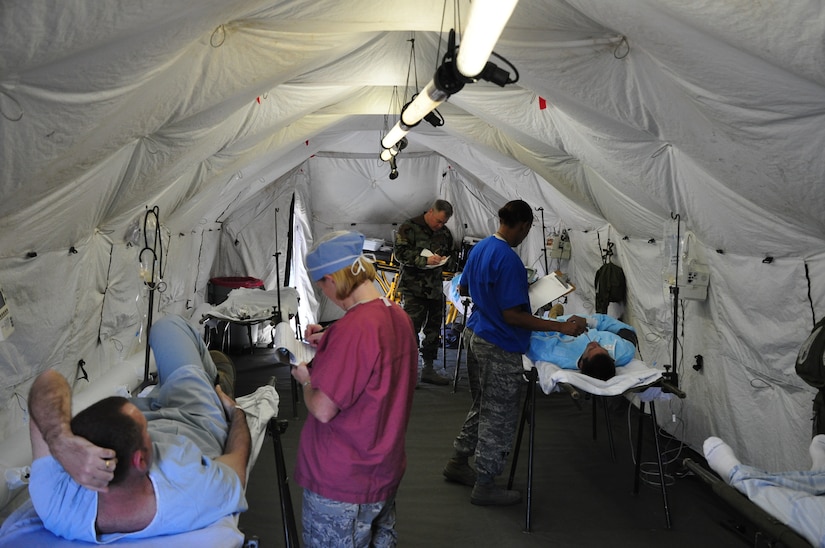 SOTO CANO AIR BASE, Honduras —  Members of the mobile surgical team pre-screen patients during an exercise here Dec. 10. The team itself is 100 percent mobile with a two-hour activation response time, and it can function alone for up to 72 hours. Their capabilities are to provide five major life- or limb-saving operations consecutively, and provide advanced trauma life support to 15 patients as well as providing limited post-operative recovery for surgical patients prior to evacuation (U.S. Air Force photo/Staff Sgt. Chad Thompson).