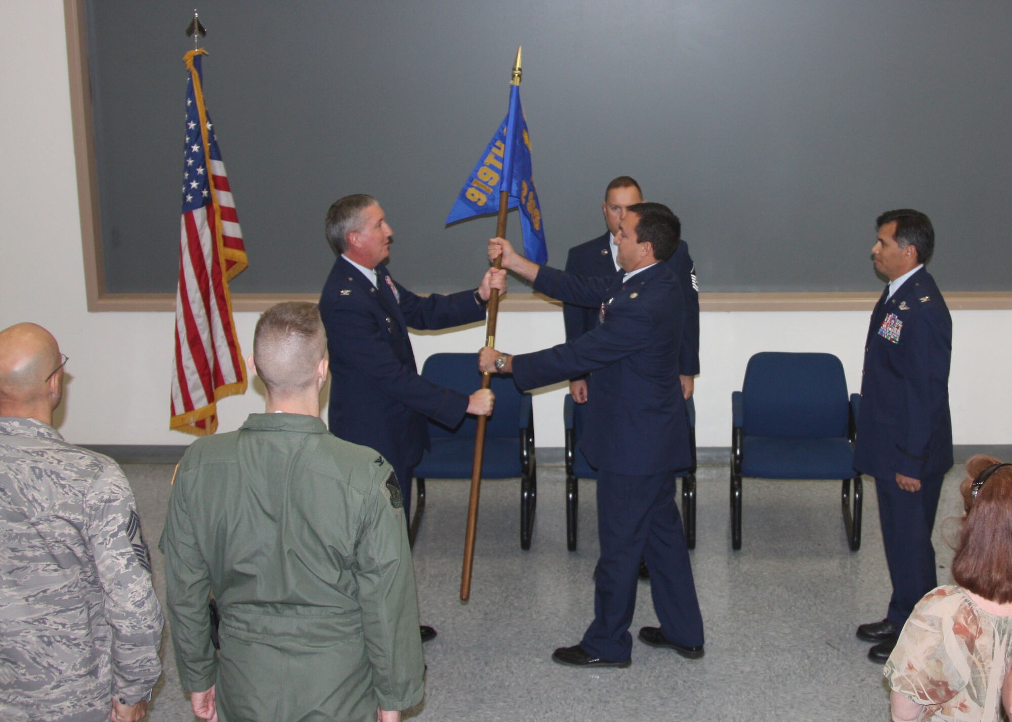 Lt. Col. Brett Buras, right, receives the 2nd Special Operations Squadron guidon from Col. Jon Weeks, 919th Special Operations Wing commander, Nov. 21 during a change of command ceremony at Nellis Air Force Base, Nev.  Colonel Buras replaced Col. Ray Pijma as newest commander of the unit which operates a 24/7 Predator unmanned aerial system combat air patrol for Overseas Contingency Operations, the only Air Force Reserve unit to conduct such a mission. (Courtesy photo)