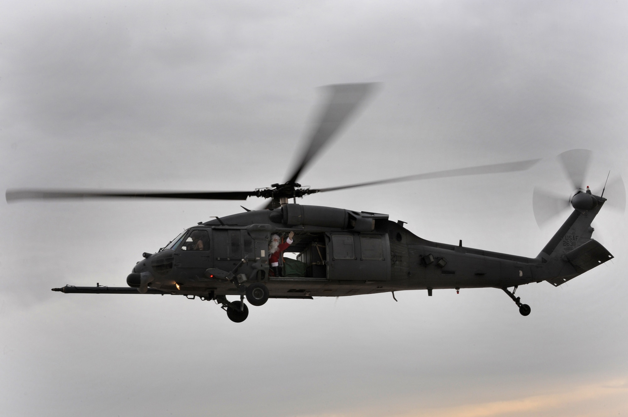NELLIS AIR FORCE BASE, Nev.-- Santa Claus waves to a crowd of children from a HH-60G Pavehawk helicopter at the Nellis rescue community's annual children's Christmas party Dec. 12. 
(U.S. Air Force photo by Tech. Sgt. Michael R. Holzworth)
