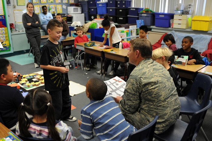NELLIS AIR FORCE BASE, Nev.--  Ethan Green, a third-grade student from Lomie Gray Heard Elementary School, introduces himself and presents his building proposal to Col. Steven Winklmann, 99th Air Base Wing vice commander, during the final phase of the Junior Planner Box City project Dec. 10.  Colonel Winklmann spent the afternoon as acting mayor of Candy Town, helping the children at the elementary school construct and place buildings throughout their make-believe community. The architectural project helped the children understand the many different aspects that go into planning and creating a community.
(U.S. Air Force photo by Tech. Sgt. Michael R. Holzworth)
