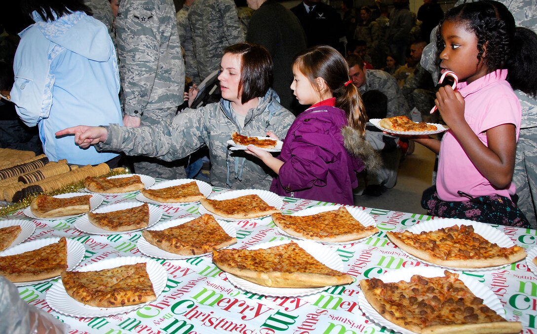 Children and their sponsors walk through the refreshments line during the Give a Child a Christmas event at the Community Center. Two hundred students from local elementary schools in Wichita Falls, Texas, were sponsored by Team Sheppard. (U.S. Air Force photo/Harry Tonemah)