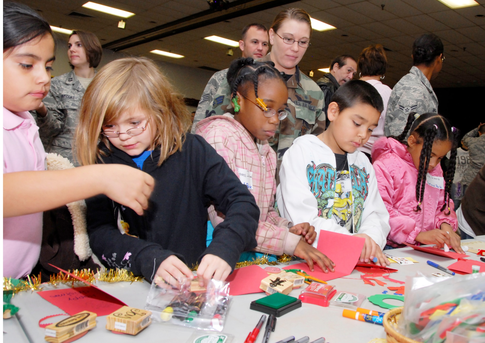 Children from local elementary schools in Wichita Falls, Texas, create various arts and crafts during the Give a Child a Christmas event at the Community Center Dec.11. Two hundred students were sponsored by Team Sheppard. (U.S. Air Force photo/Harry Tonemah)