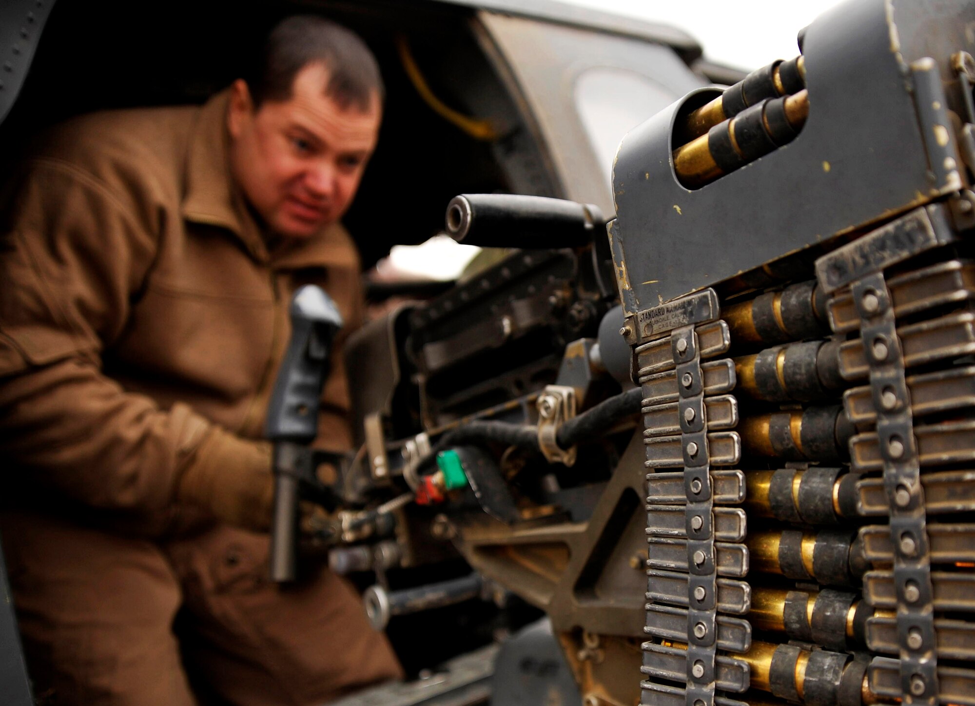 U.S. Air Force Master Sgt. Don Ballowe, 66th Expeditionary Rescue Squadron flight engineer, deployed to Camp Bastion, Afghanistan, inspects his 50-caliber machine gun, Dec. 8, 2009.  While the crew pre-loads the aircraft, they also inspect their equipment to ensure it is properly working before a rescue mission. (U.S. Air Force photo/Staff Sgt. Angelita Lawrence)