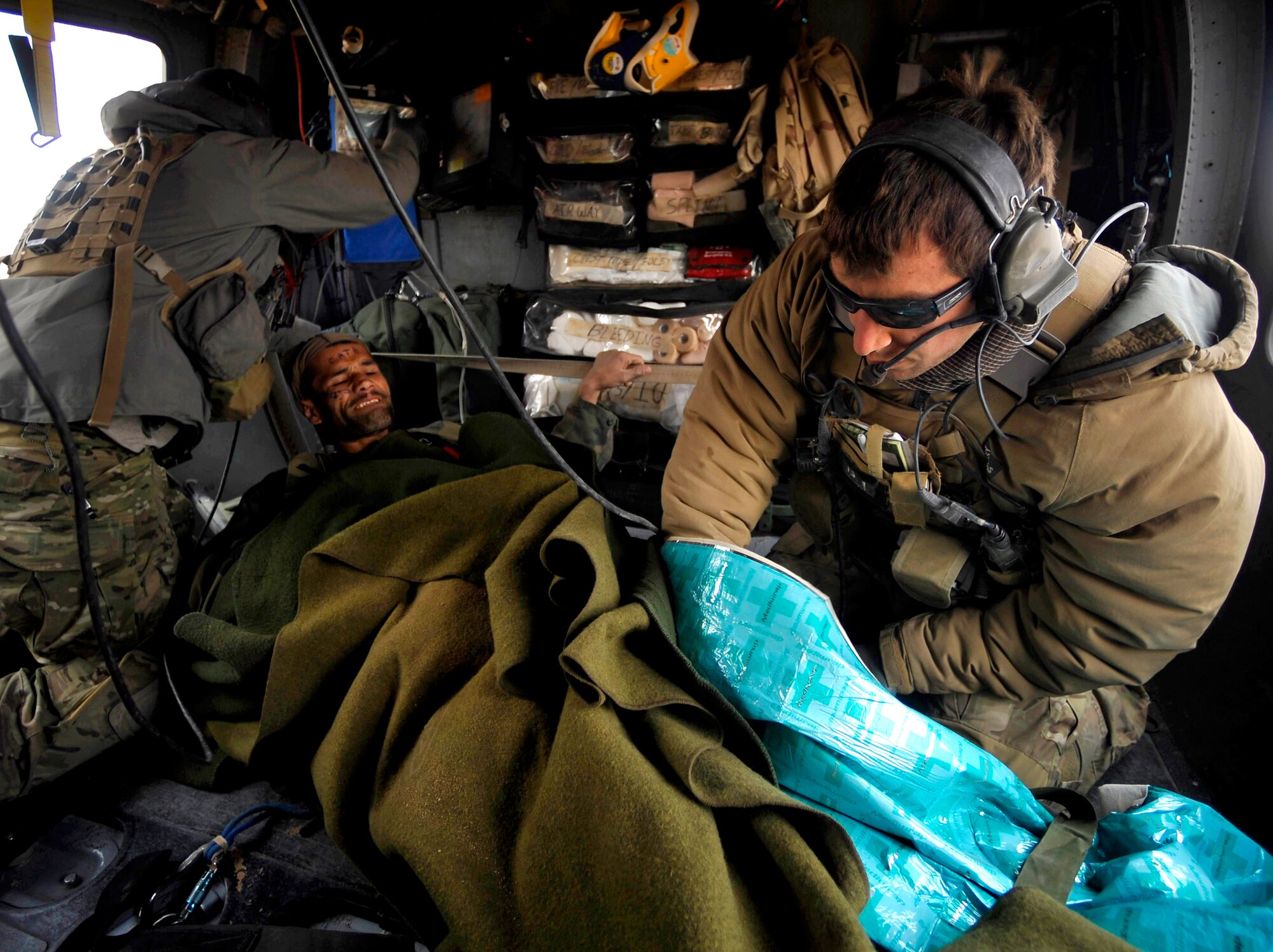 U.S. Air Force Pararescuemen from the 66th Expeditionary Rescue Squadron deployed to Camp Bastion, Afghanistan, provide medical attention to an Afghan who has suffered gunshot injuries, Dec. 08, 2009.  The PJs are able to rescue patients in any situation who need medical attention.  (U.S. Air Force photo/Staff Sgt. Angelita Lawrence)
