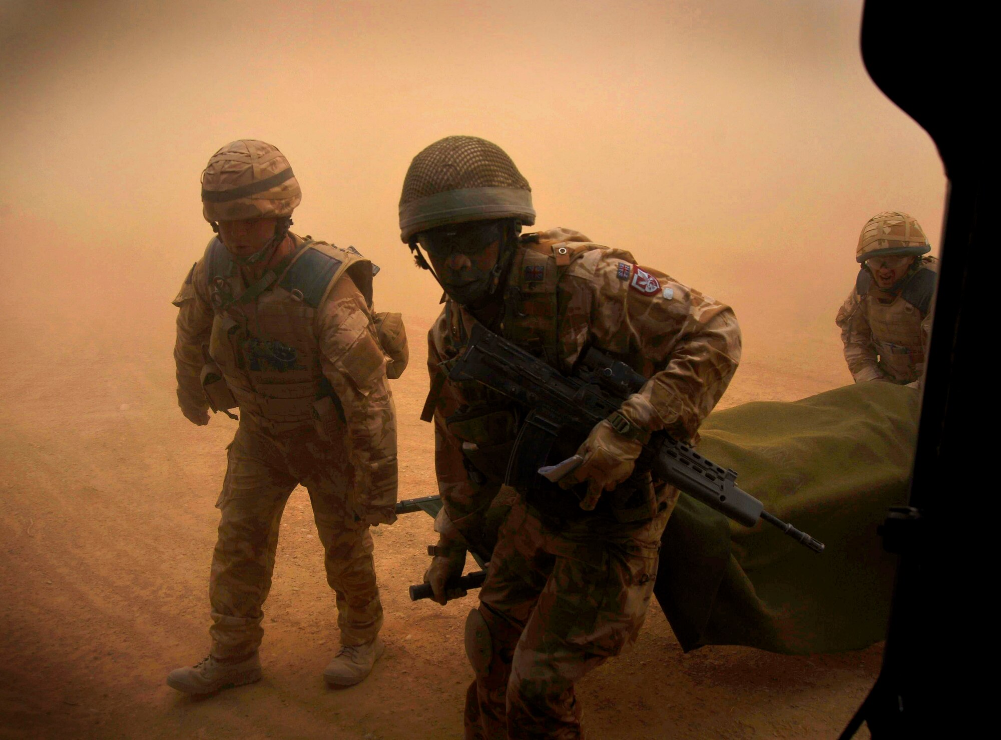 U.S. Air Force Pararescuemen from the 66th Expeditionary Rescue Squadron deployed to Camp Bastion, Afghanistan, receive an injured patient from Coalition Forces, Dec. 8, 2009.  The pararecuemen will administer medical care while in transit to a medical facility.  (U.S. Air Force photo/Staff Sgt. Angelita Lawrence)