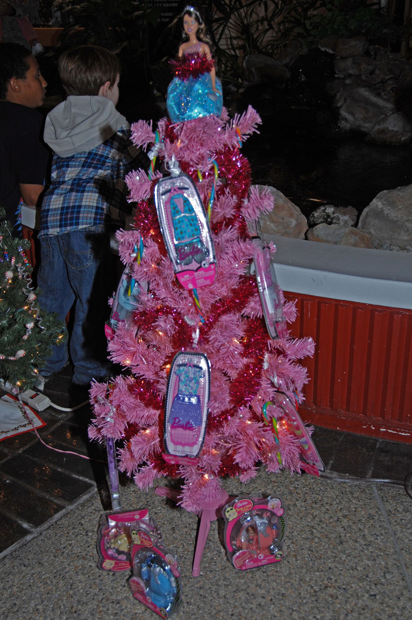 TRAVIS AIR FORCE BASE, Calif. -- A favorite at the Travis Air Force Base tree auction was the pink Barbie tree. This is just one of the uniquely decorated trees auctioned off Dec. 4 at Travis Air Force Base, to benefit the Travis Fisher House. Each year, the 60th Maintenance Operations Squadron and the 349th Maintenance Operations Flight host a Tree Festival and Auction for this cause. Fisher Houses were the brainchild of Zachary and Elizabeth Fisher, who wanted to create a foundation to help military families in need, where they can stay, without charge, by the hospital where their military loved one is being treated. Located on the grounds of David Grant USAF Medical Center, the Travis Fisher House is one of more than 30 built by this foundation. This year's festival raised about $2,700. (U.S. Air Force photo Senior Master Sgt. Ellen L. Hatfield)