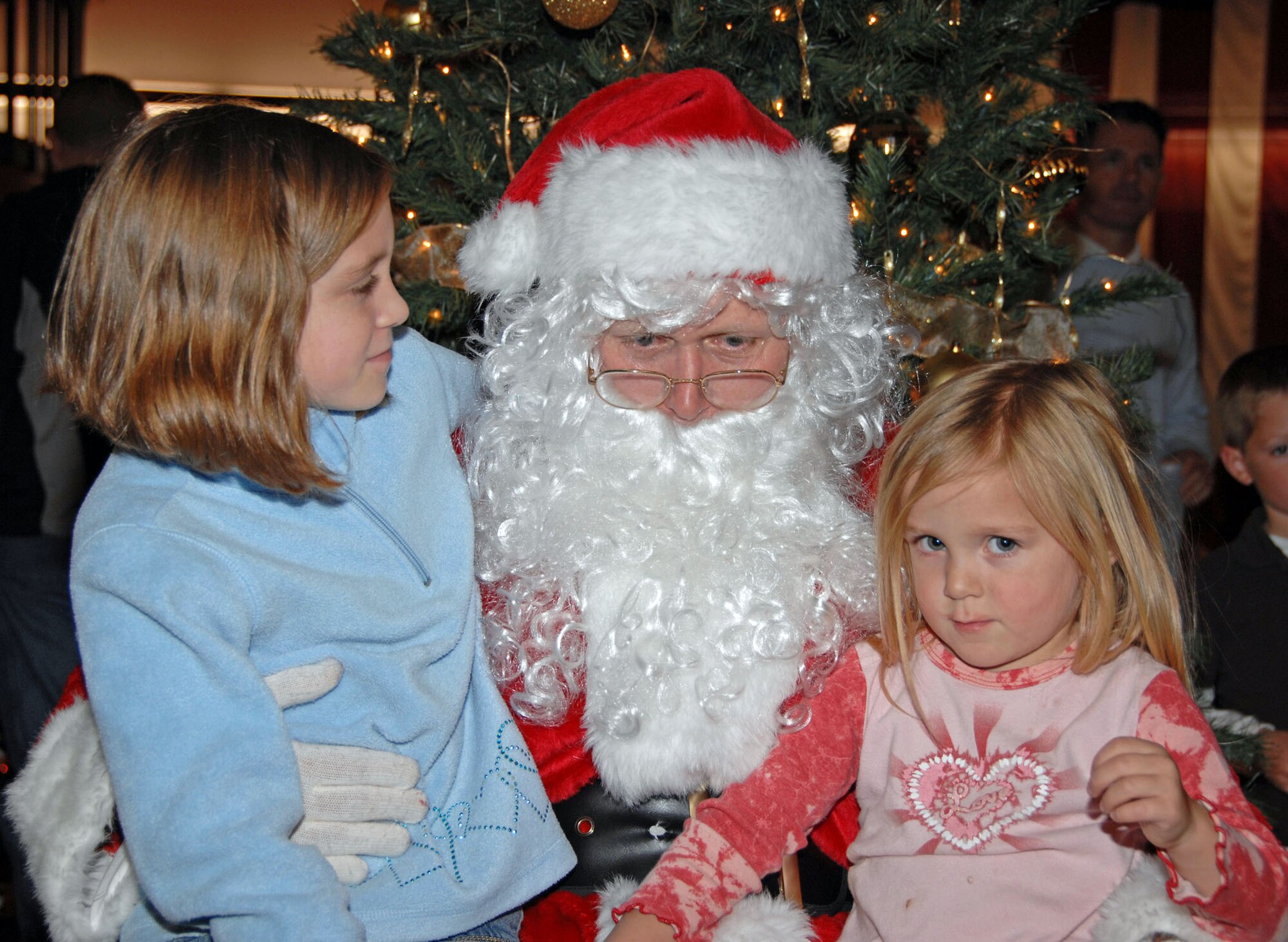 TRAVIS AIR FORCE BASE, Calif. -- Santa Clause dropped in to visit with the children of Team Travis Airmen Dec. 4, at the Tree Festival and Auction. He listened to their toy requests before being whisked away to pick up his sleigh. Each year, the 60th Maintenance Operations Squadron and the 349th Maintenance Operations Flight host a Tree Festival and Auction to benefit the Travis Fisher House. Fisher Houses were the brainchild of Zachary and Elizabeth Fisher, who wanted to create a foundation to help military families in need, where they can stay, without charge, by the hospital where their military loved one is being treated. Located on the grounds of David Grant USAF Medical Center, the Travis Fisher House is one of more than 30 built by this foundation. This year's festival raised about $2,700. (U.S. Air Force/photo SMSgt. Ellen L. Hatfield) (U.S. Air Force/photo Senior Master Sgt. Ellen L. Hatfield)