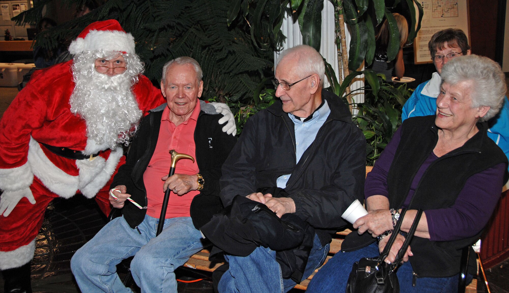 TRAVIS AIR FORCE BASE, Calif. -- Santa Clause dropped in to visit with "kids from one to 92" Dec. 4, at the Team Travis Tree Festival and Auction. He listened to their requests before being whisked away to pick up his sleigh. Each year, the 60th Maintenance Operations Squadron and the 349th Maintenance Operations Flight host a Tree Festival and Auction to benefit the Travis Fisher House. Fisher Houses were the brainchild of Zachary and Elizabeth Fisher, who wanted to create a foundation to help military families in need, where they can stay, without charge, by the hospital where their military loved one is being treated. Located on the grounds of David Grant USAF Medical Center, the Travis Fisher House is one of more than 30 built by this foundation. This year's festival raised about $2,700. (U.S. Air Force/photo Senior Master Sgt. Ellen L. Hatfield)