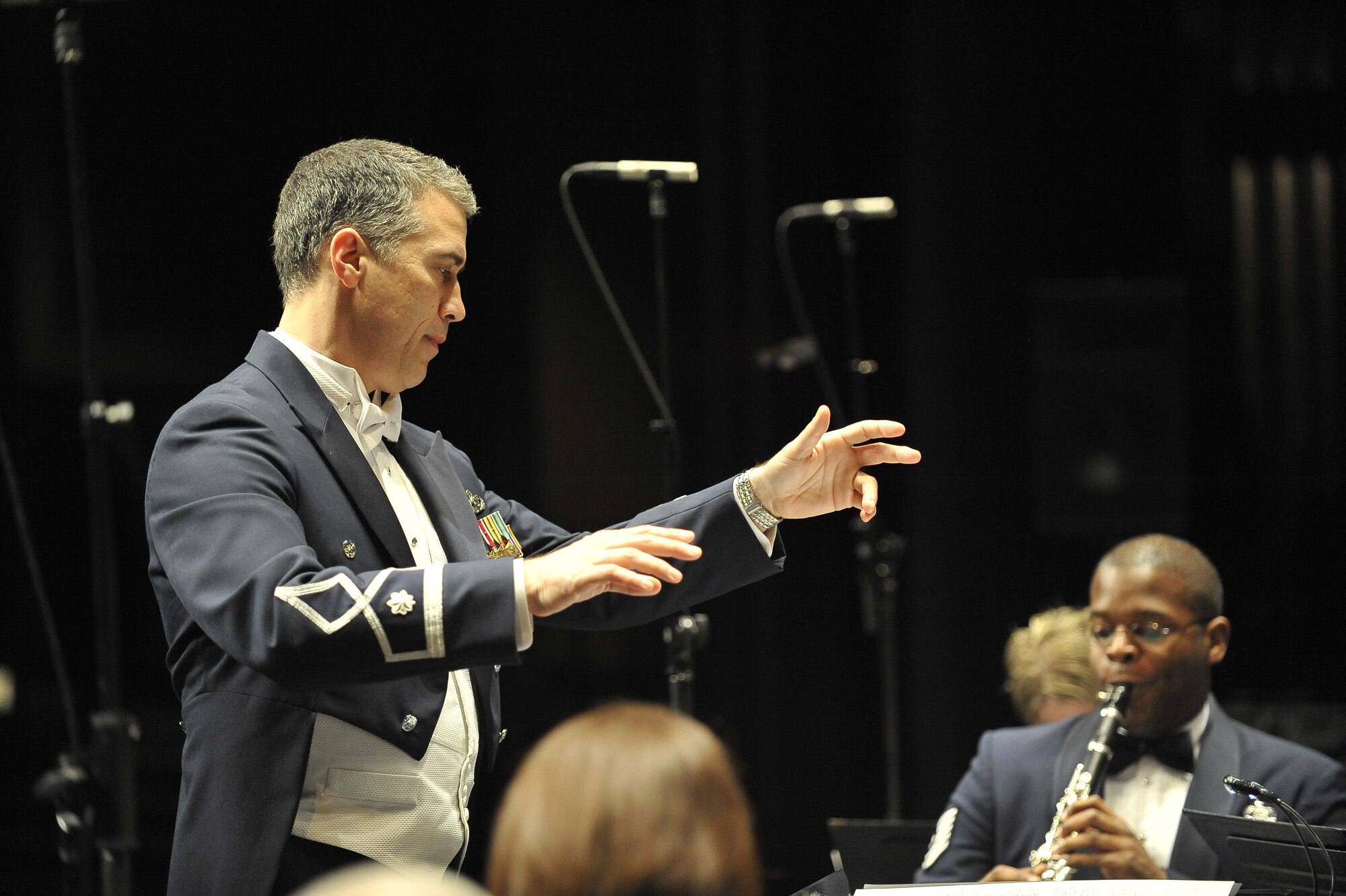 U.S. Air Force Lt. Col. Douglas Monroe conducts the United States Air Force Heritage of America Band at the North Charleston Performing Arts Center in North Charleston, S.C., Dec. 9, 2009. For more than half a century, the band has represented the Air Force with musical and military distinction. Colonel Monroe is the commander and conductor for the Heritage band. (U.S. Air Force photo by James M. Bowman)(Released)