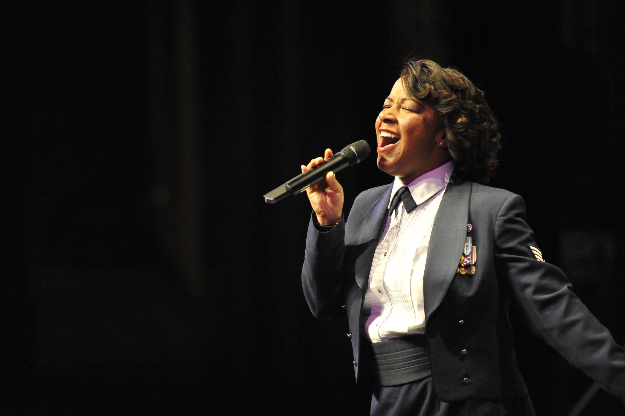 U.S. Air Force Staff Sgt. Natalie Madison sings during the United States Air Force Heritage of America Band show at the North Charleston Performing Arts Center in North Charleston, S.C., Dec. 9, 2009. The United States Air Force Heritage of America Band has a rich history of inspiring hearts and minds, building and sustaining American patriotism and enhancing esprit de corps in the United States Air Force. Sergeant Madison is a bandsman with the Air Force Heritage of America Band. (U.S. Air Force photo by James M. Bowman)(Released)